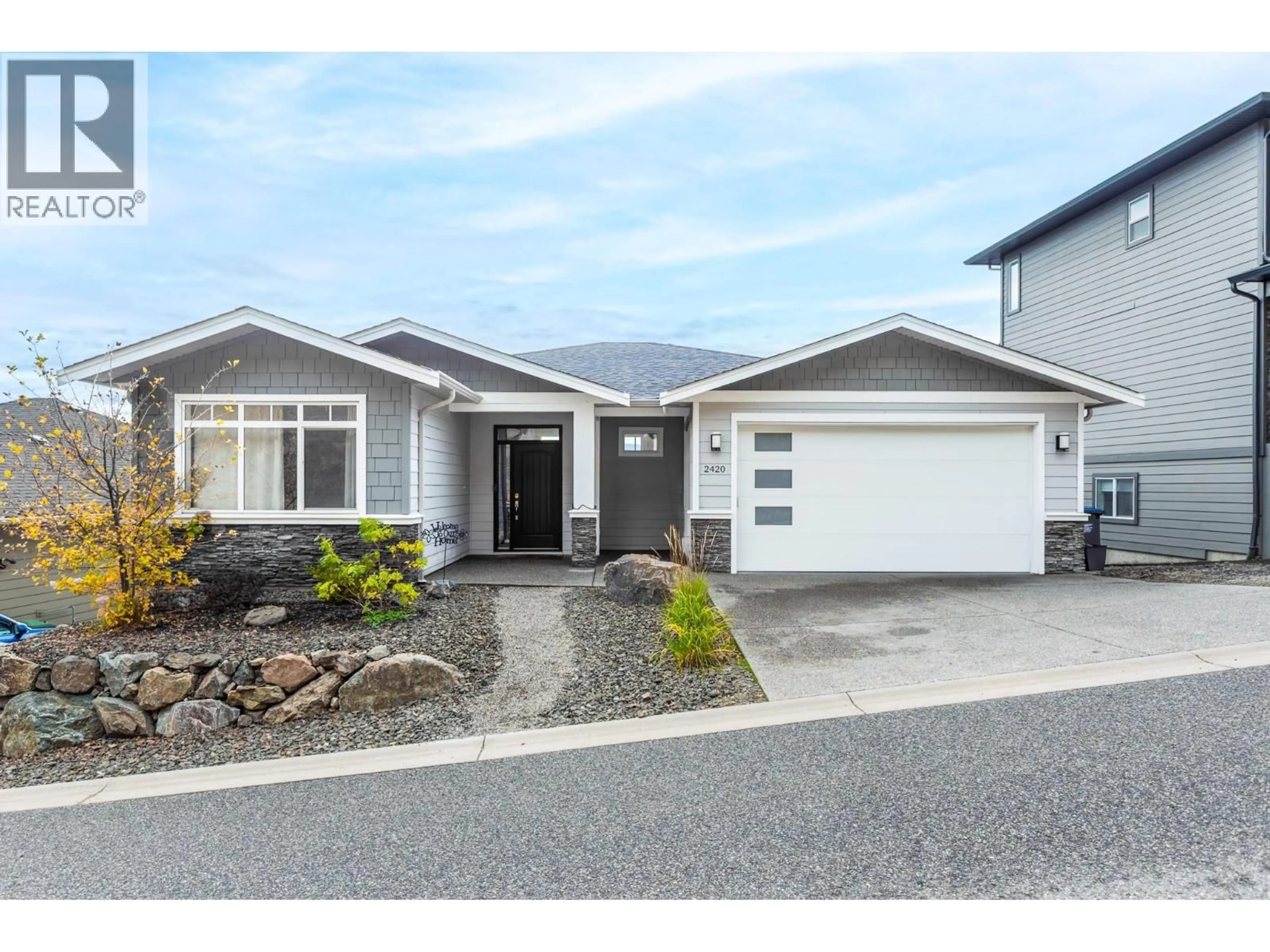 Home with vinyl exterior material, street for 2420 TALLUS HEIGHTS DRIVE, West Kelowna British Columbia V4T3M2