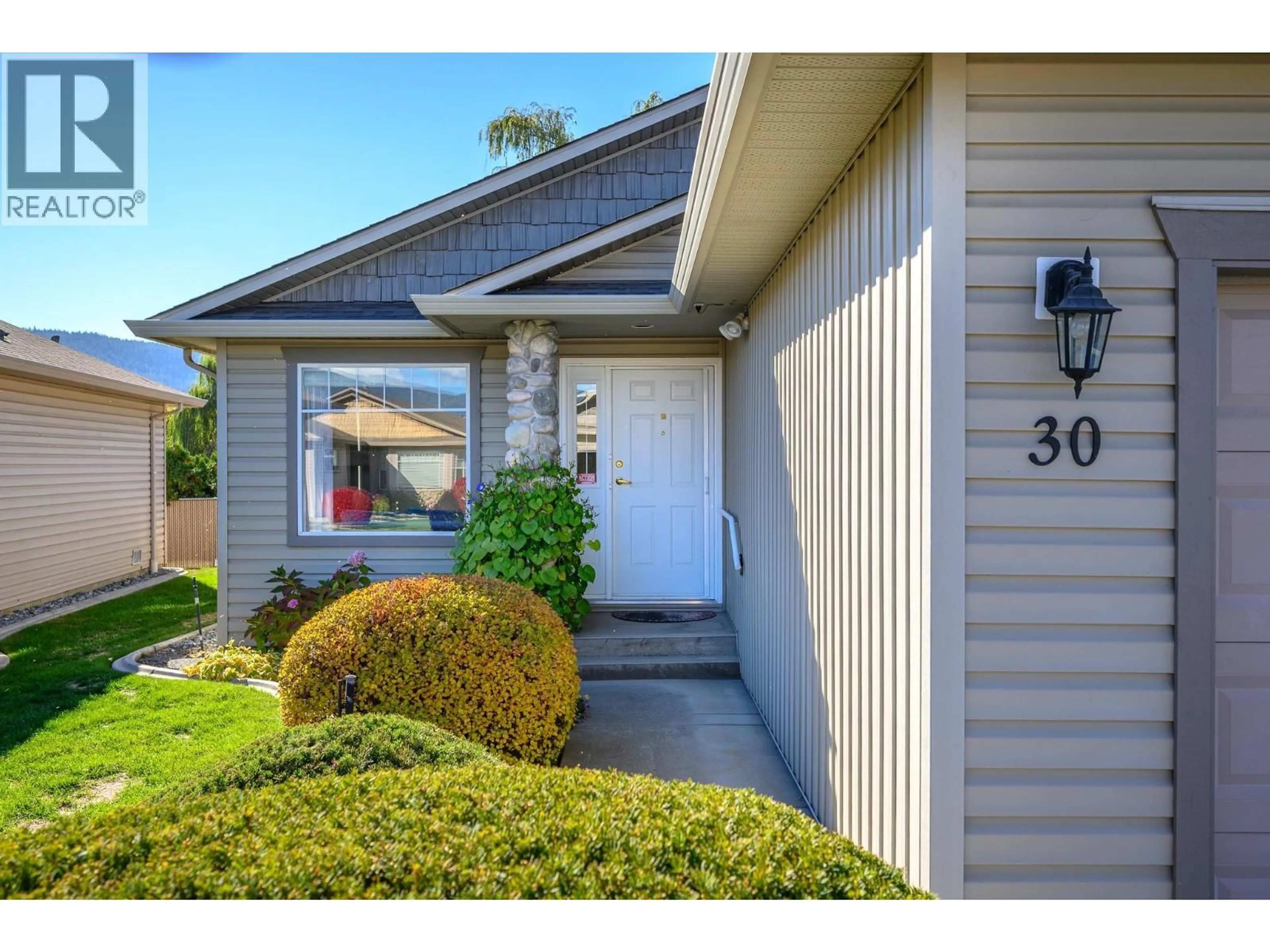 Home with vinyl exterior material, street for 30 - 5888 OKANAGAN LANDING ROAD, Vernon British Columbia V1H1S2