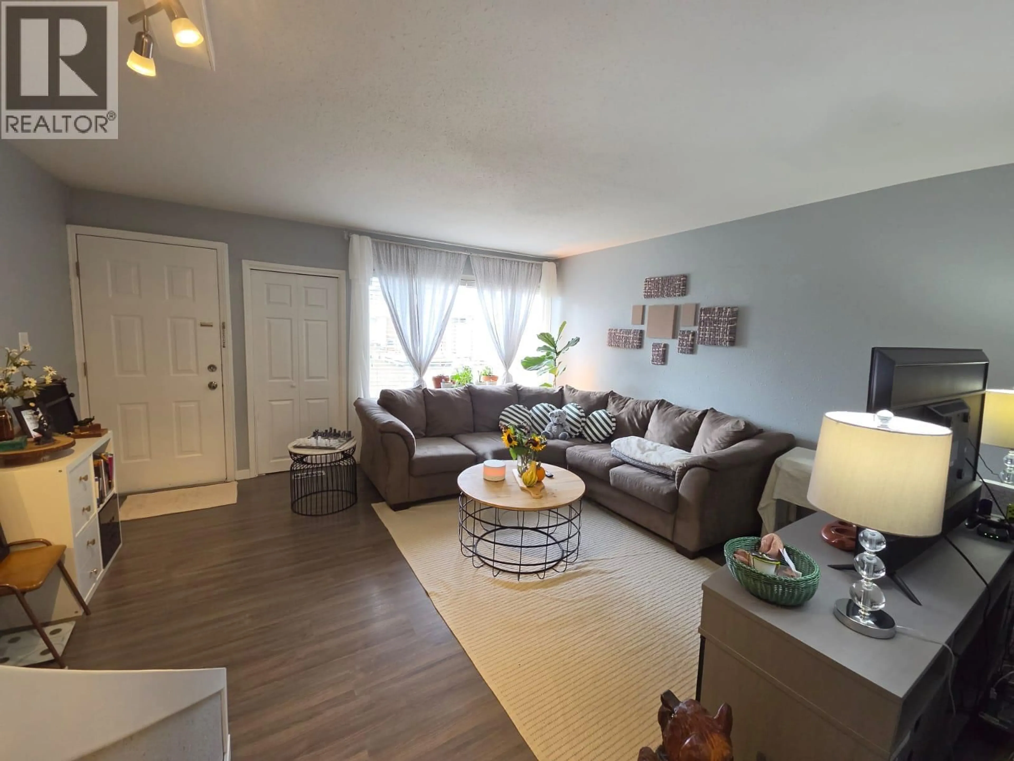 Living room with furniture, wood/laminate floor for 126 - 5100 53 STREET SOUTHWEST, Chetwynd British Columbia V0C1J0