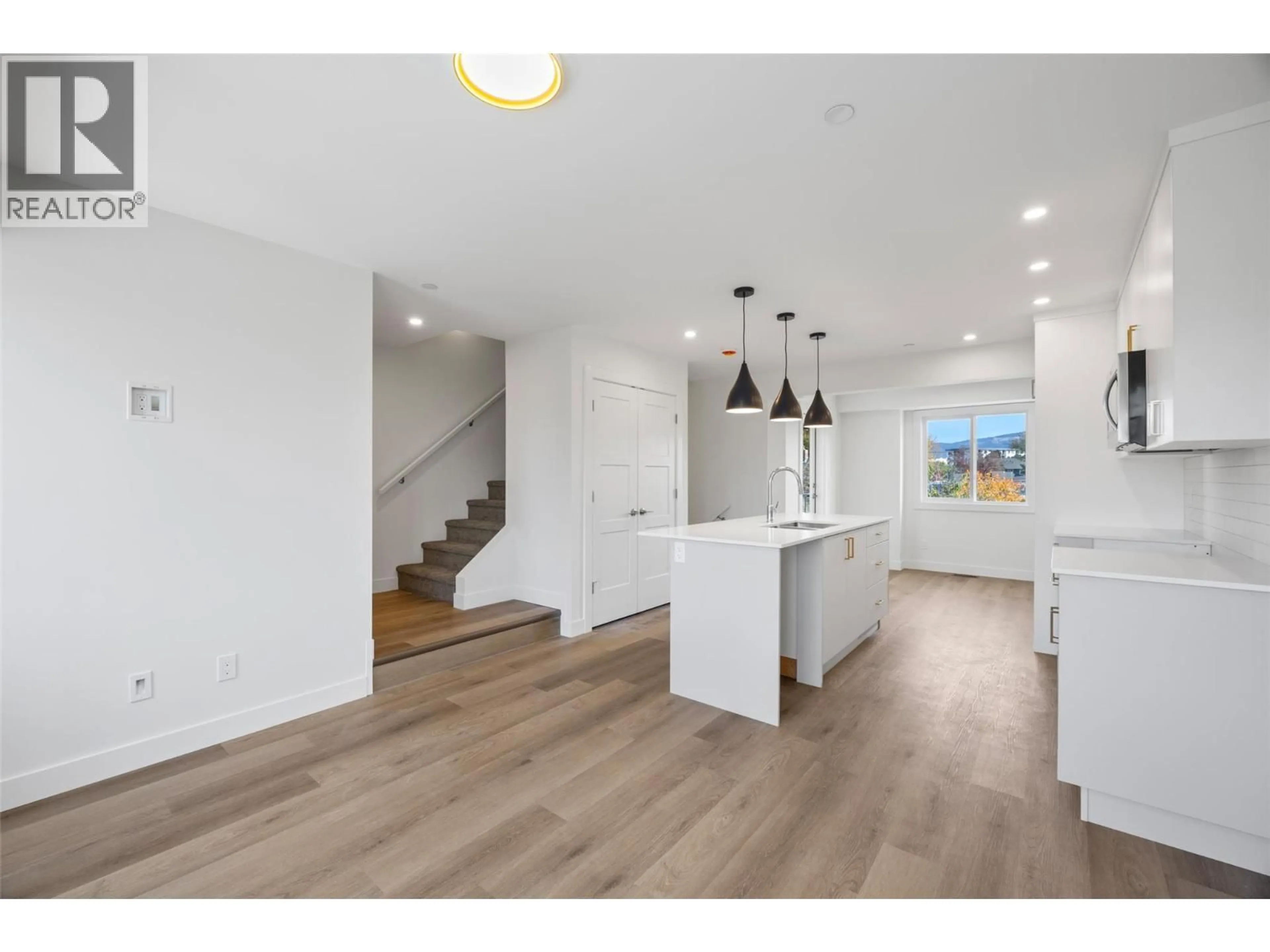 Open concept kitchen, wood/laminate floor for 151 PARK STREET, Kamloops British Columbia V2B4A7