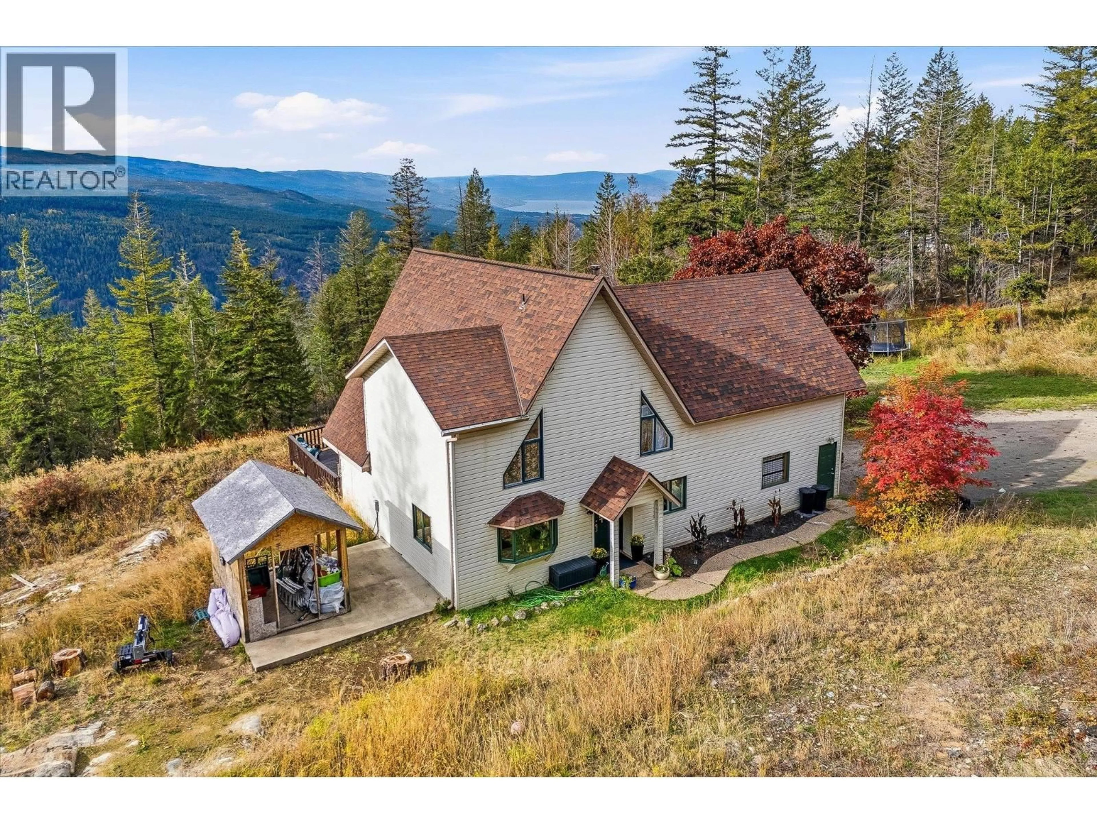 A pic from outside/outdoor area/front of a property/back of a property/a pic from drone, mountain view for 1957 HUCKLEBERRY ROAD, Kelowna British Columbia V1X4K4