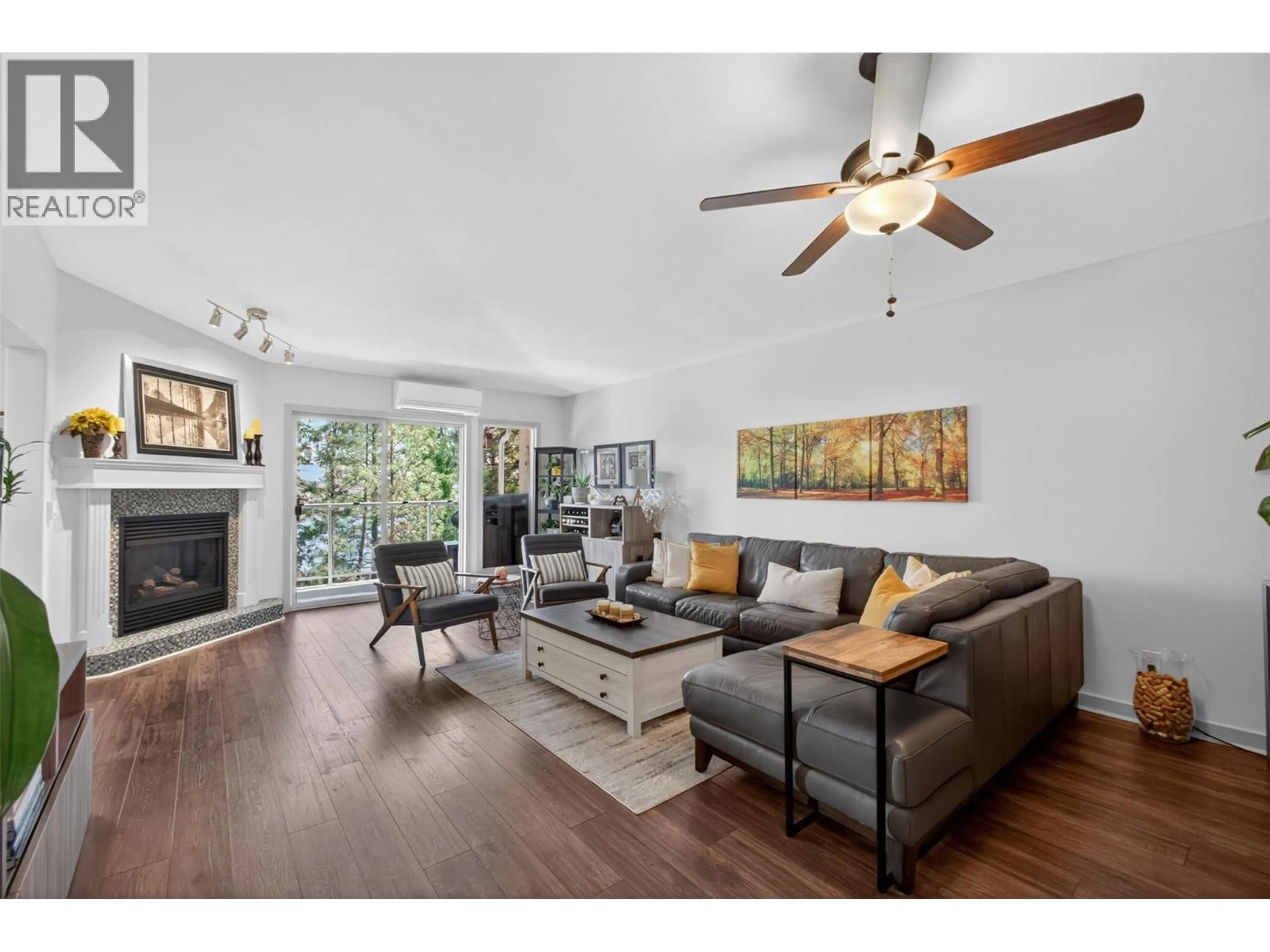 Living room with furniture, wood/laminate floor for 308 - 4630 PONDEROSA DRIVE, Peachland British Columbia V0X1H5