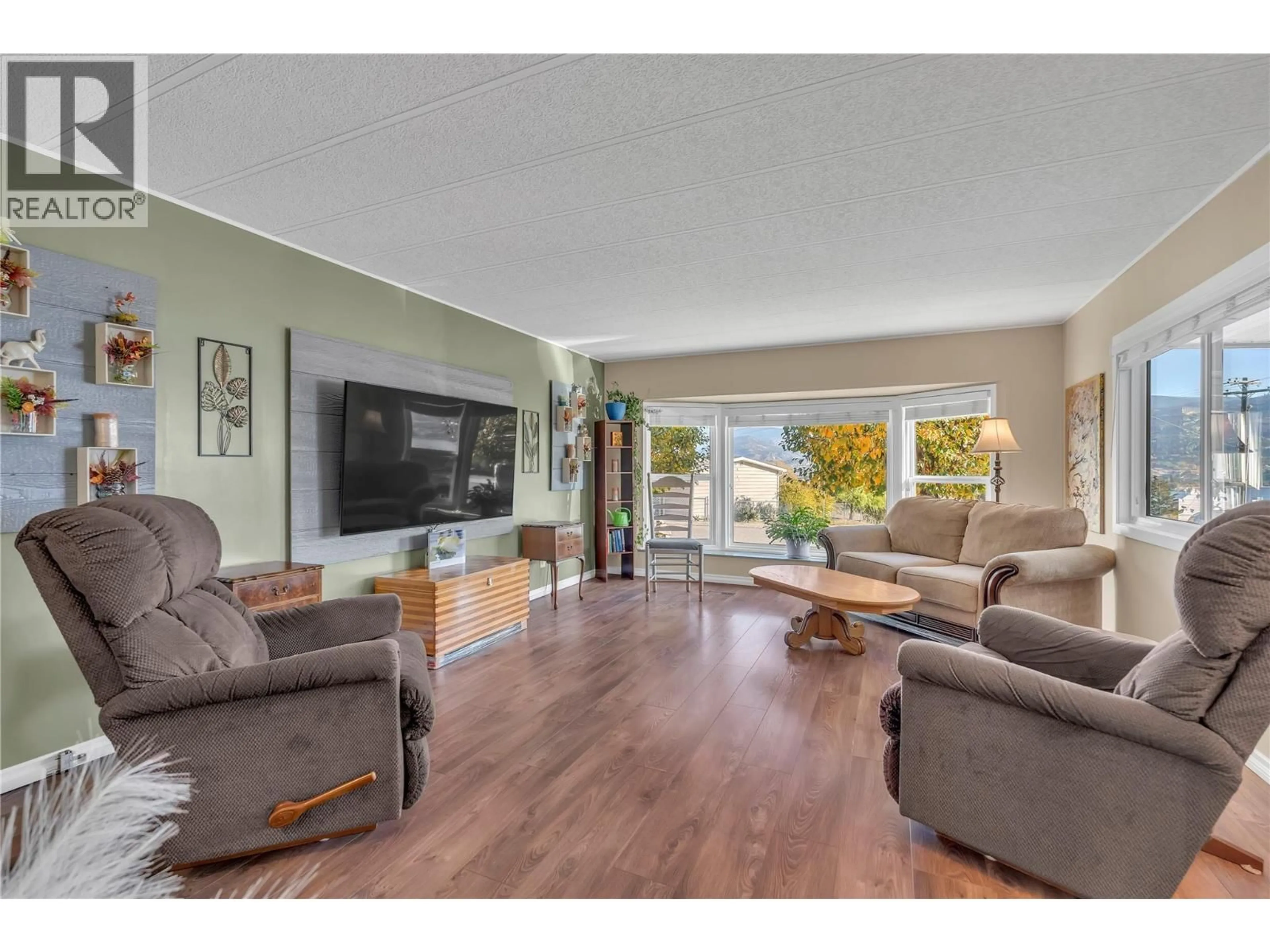 Living room with furniture, wood/laminate floor for 53 - 201 HIGHWAY 97 OTHER, Penticton British Columbia V2A6J7