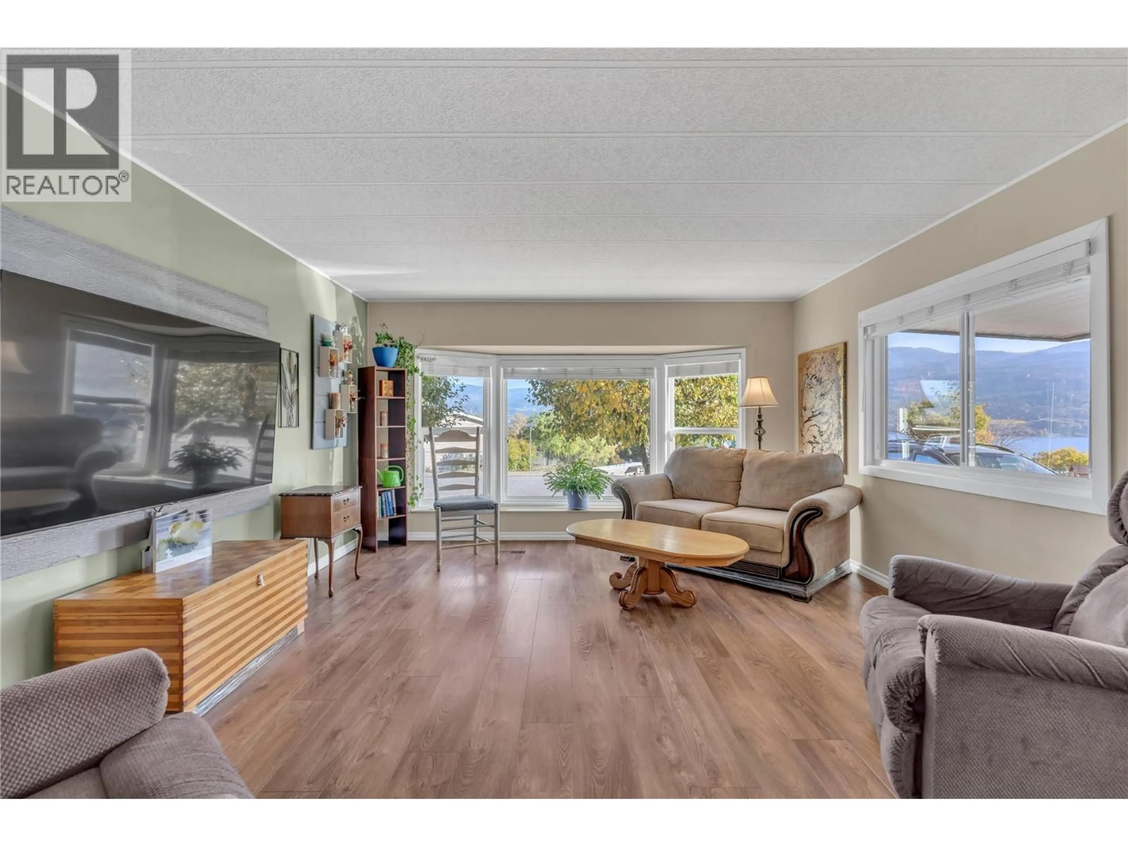 Living room with furniture, wood/laminate floor for 53 - 201 HIGHWAY 97 OTHER, Penticton British Columbia V2A6J7