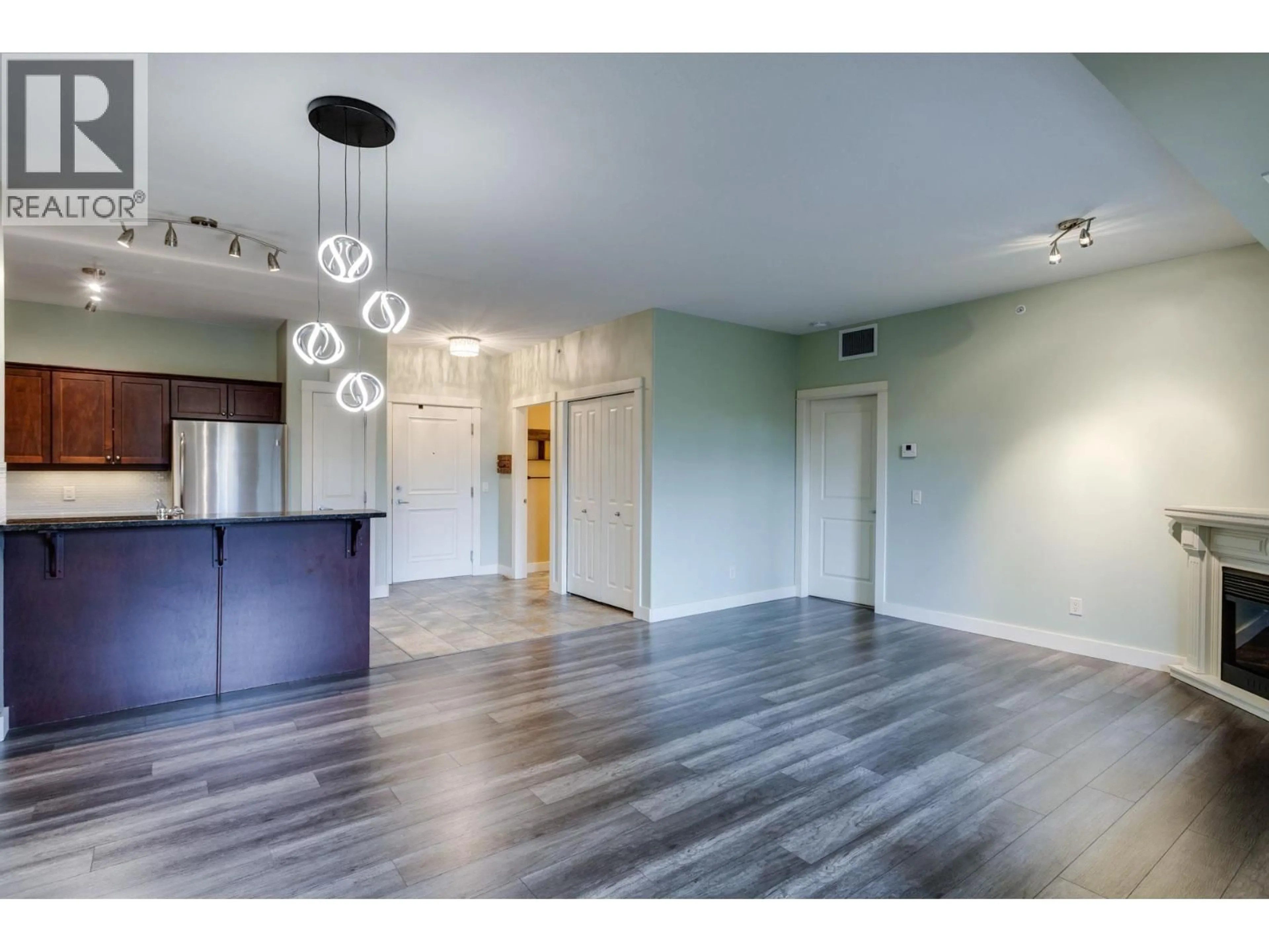 Open concept kitchen, wood/laminate floor for 219 - 2611 STILLWATER WAY, Lake Country British Columbia V4V2R3