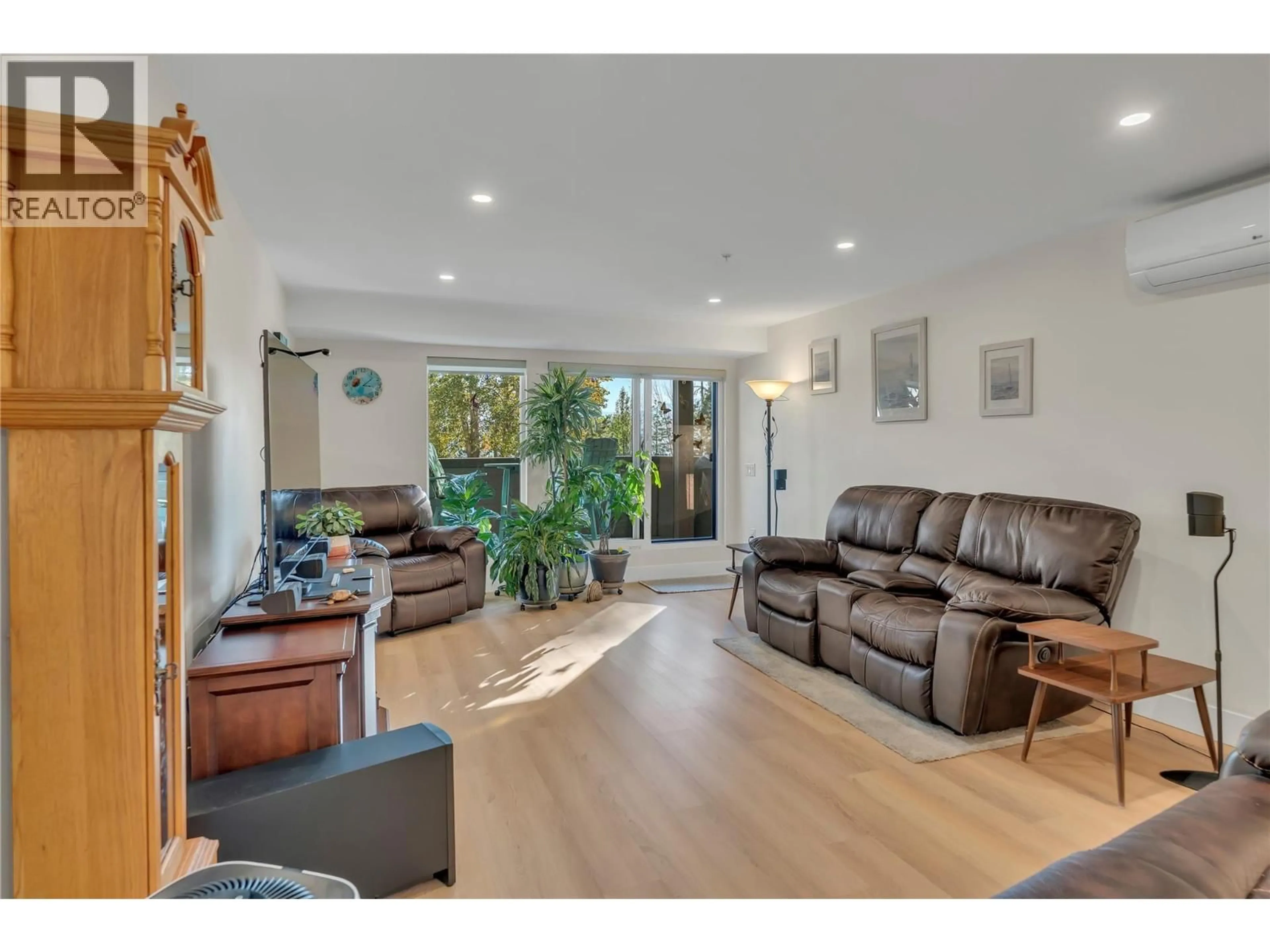 Living room with furniture, wood/laminate floor for 102 - 217 ELM AVENUE, Penticton British Columbia V2A3W1
