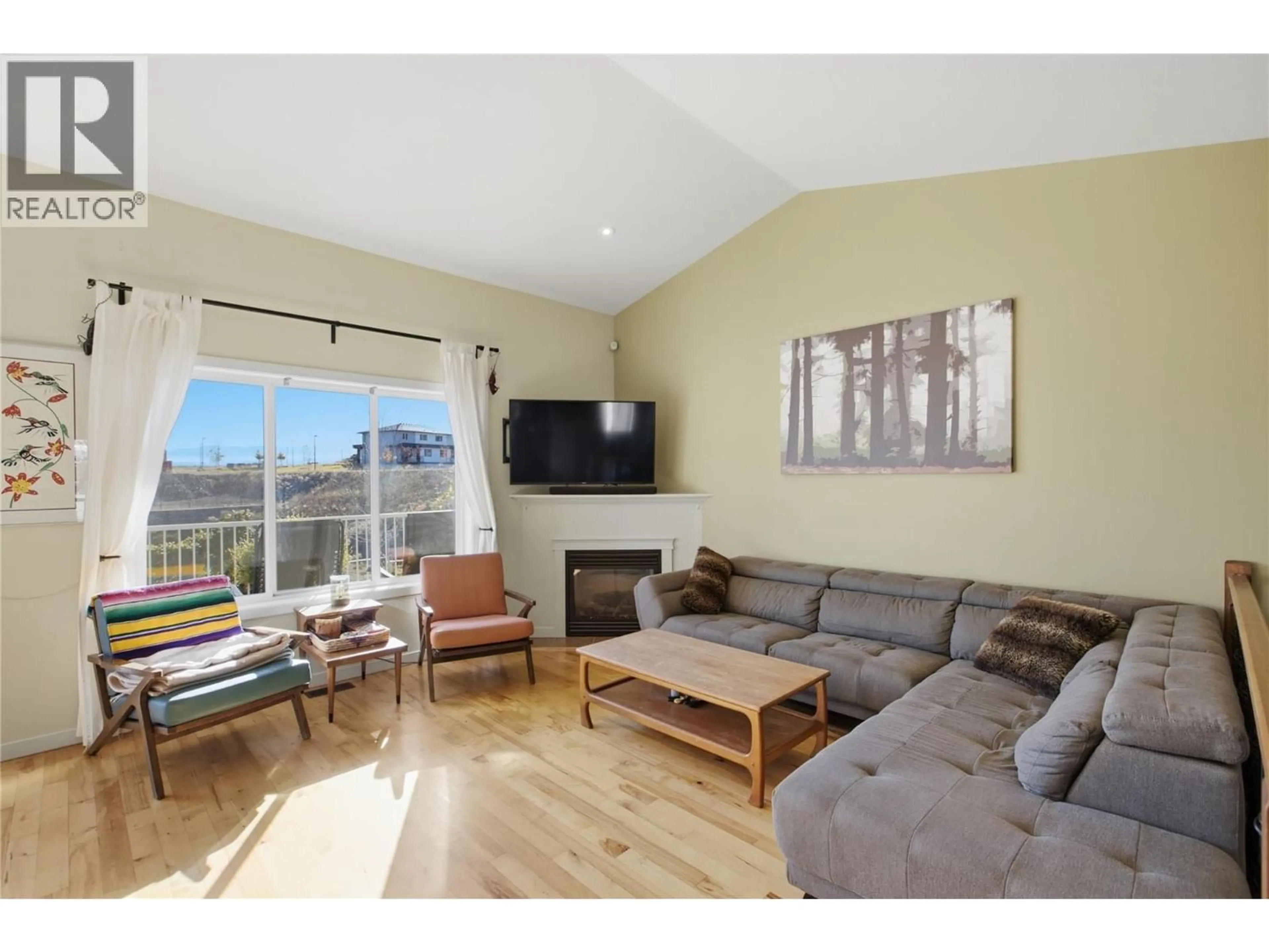 Living room with furniture, wood/laminate floor for 2060 GRASSLANDS BOULEVARD, Kamloops British Columbia V2B0A6