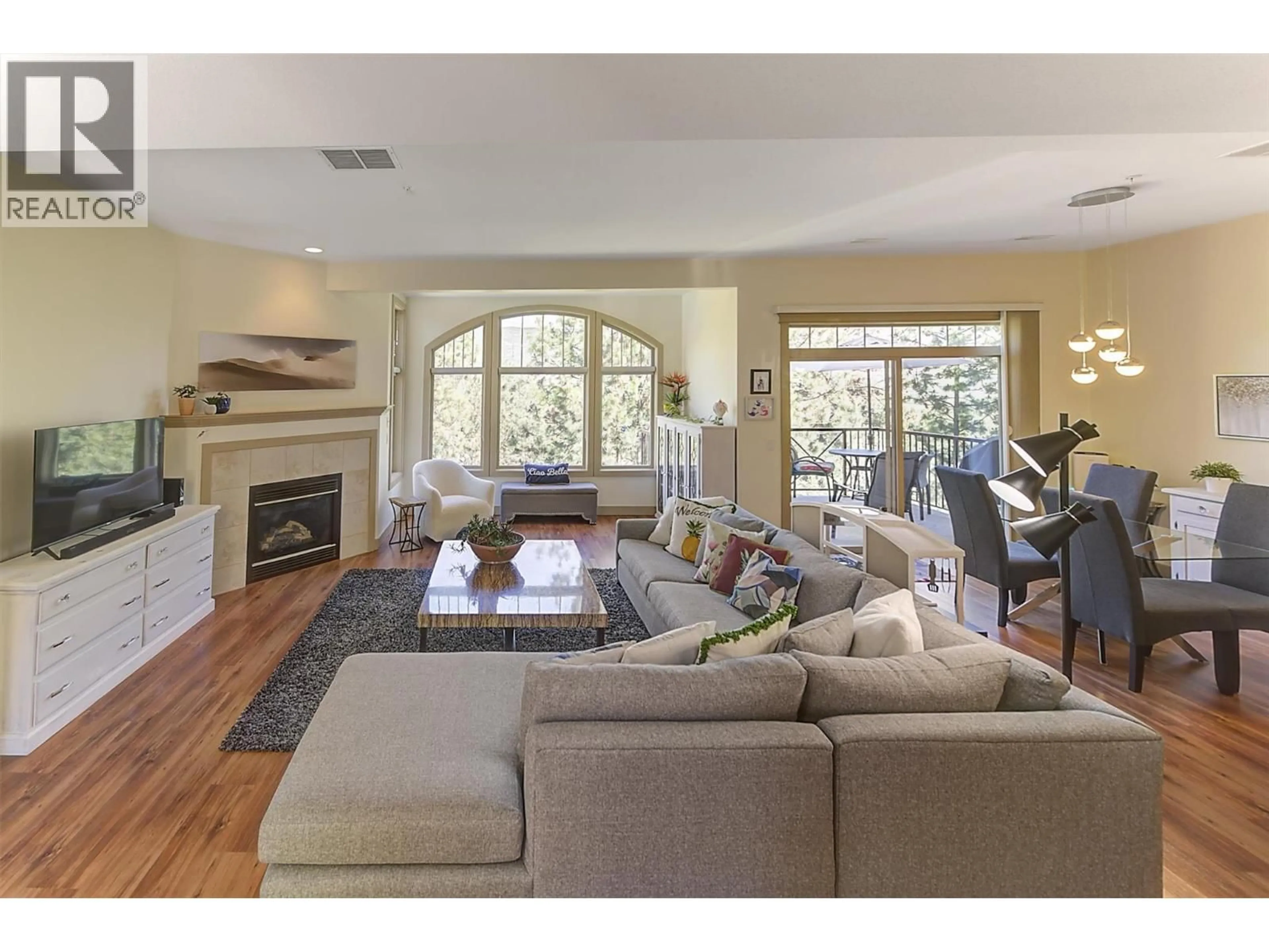 Living room with furniture, wood/laminate floor for 206 - 1795 COUNTRY CLUB ROAD, Kelowna British Columbia V1V2V9