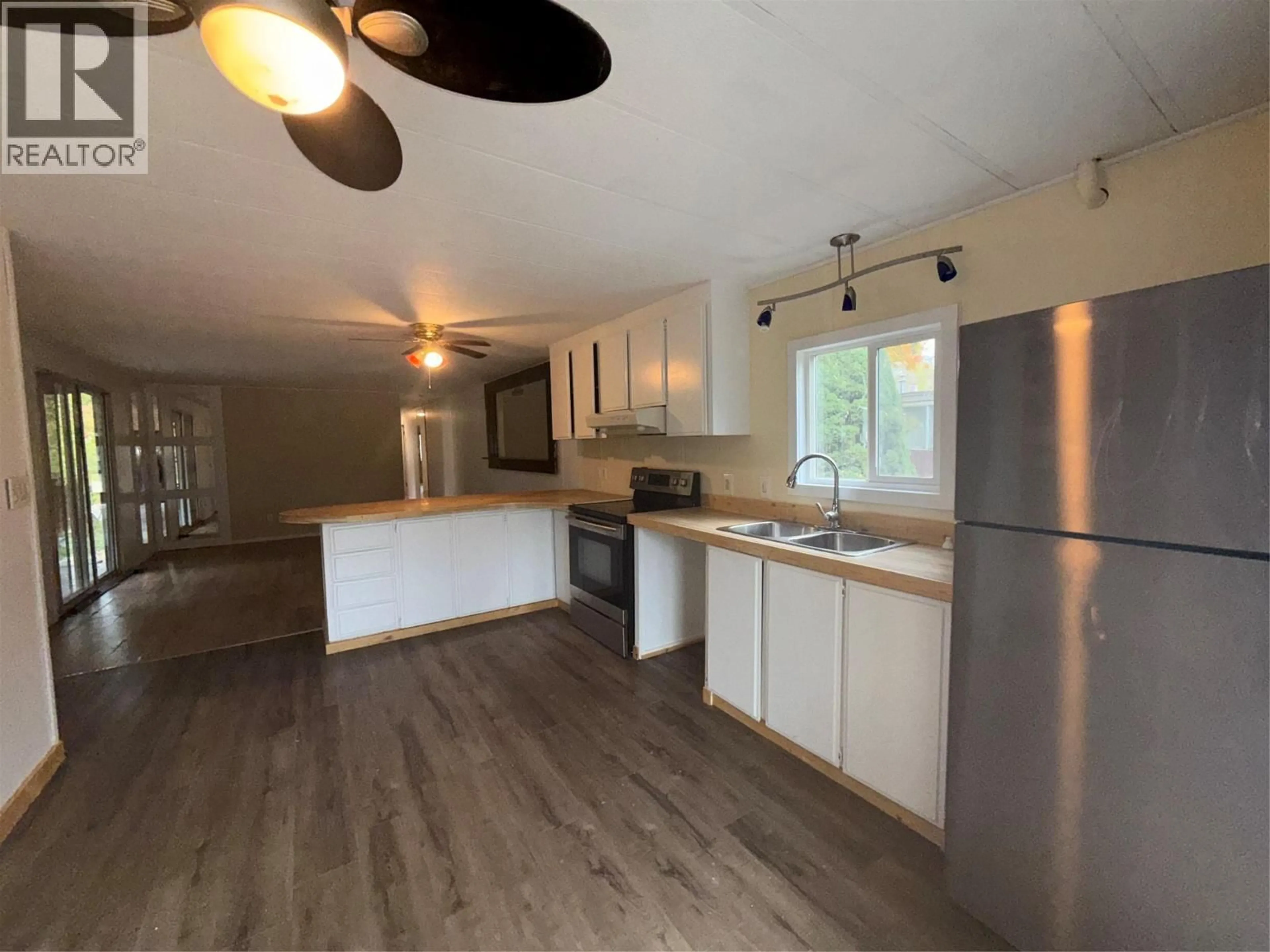 Open concept kitchen, wood/laminate floor for 405 3RD AVENUE, Castlegar British Columbia V1N1Y1