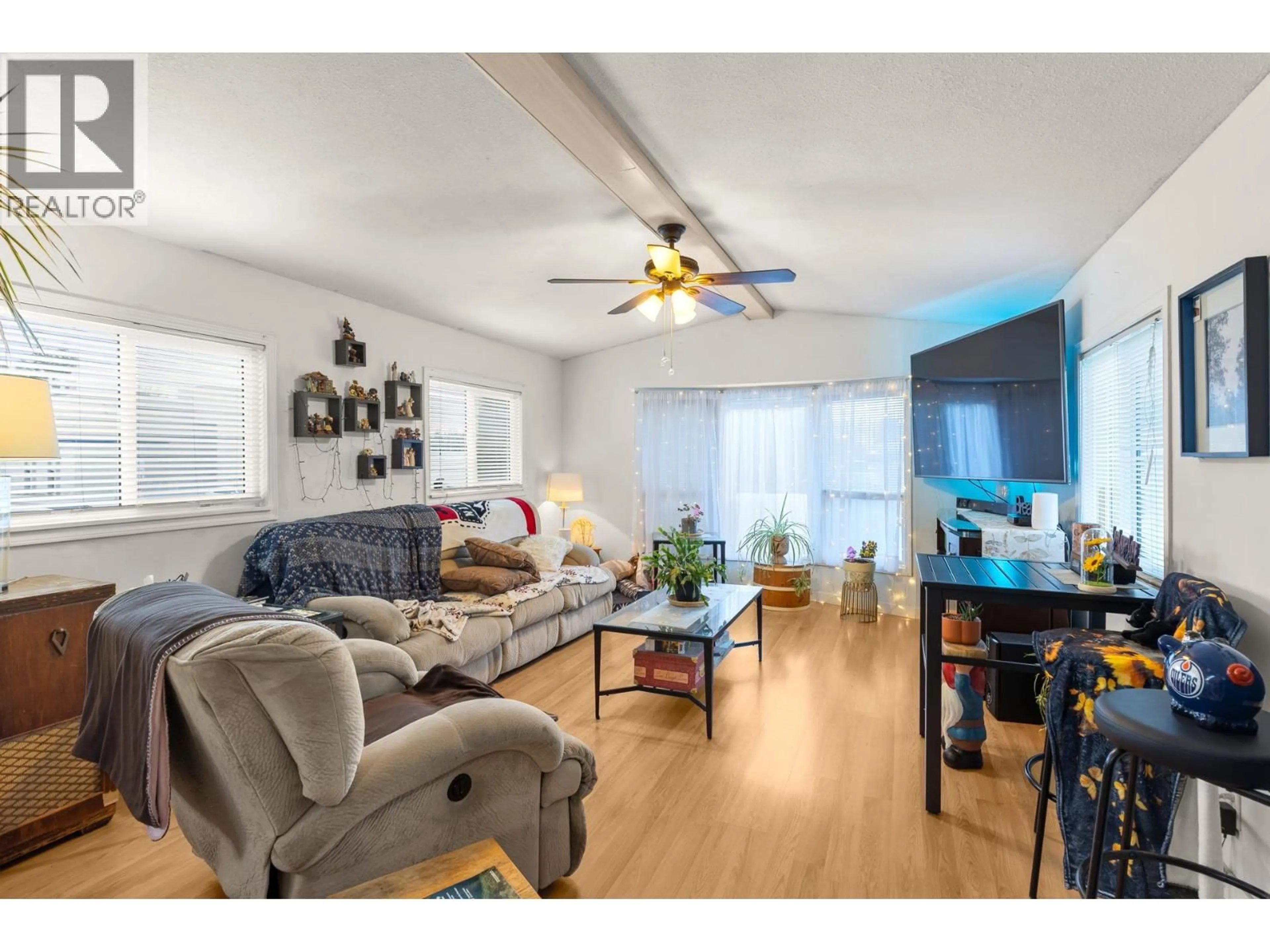 Living room with furniture, wood/laminate floor for 106 - 1699 ROSS ROAD, West Kelowna British Columbia V1Z1L8