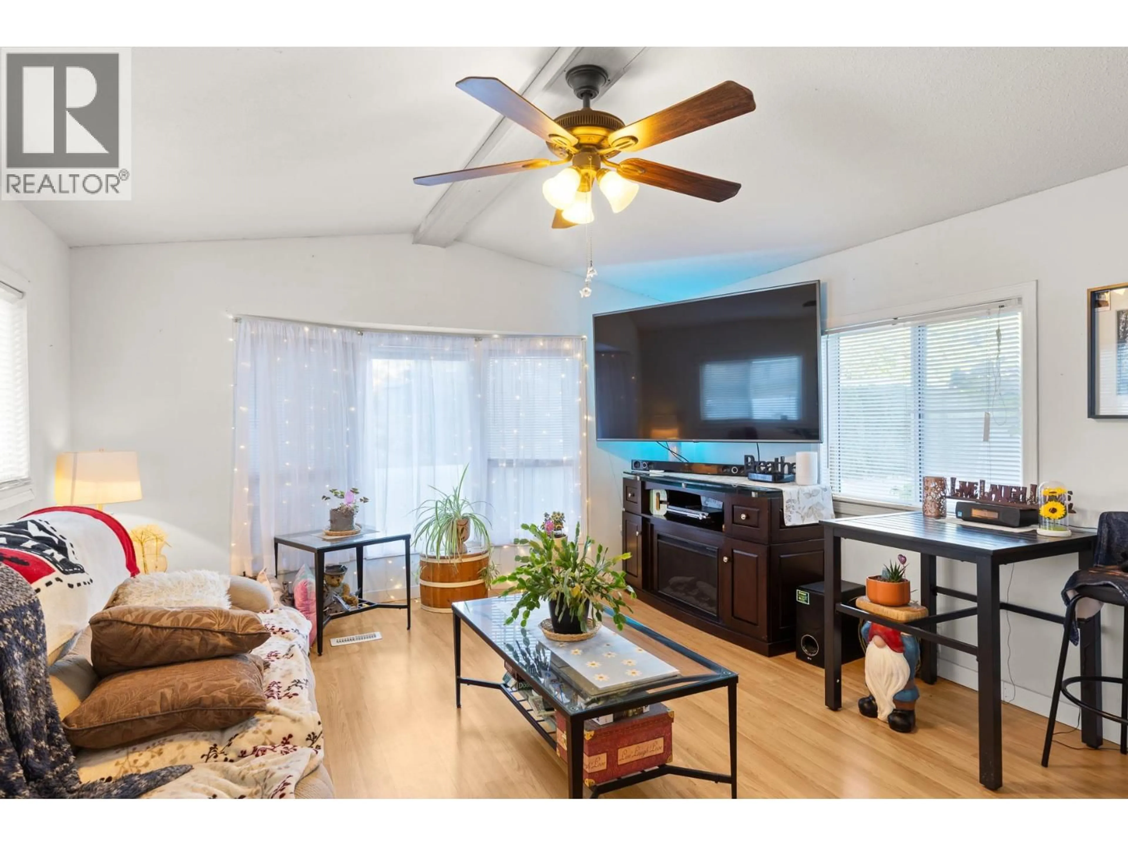 Living room with furniture, wood/laminate floor for 106 - 1699 ROSS ROAD, West Kelowna British Columbia V1Z1L8