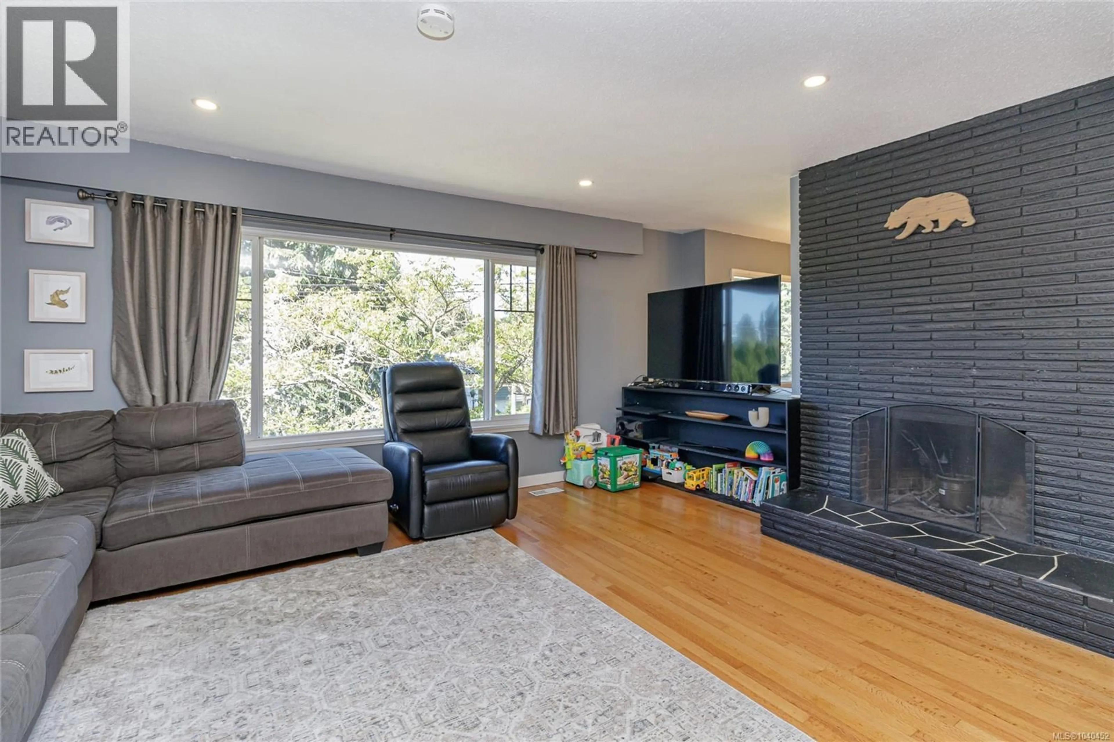 Living room with furniture, wood/laminate floor for 4067 CEDAR HILL CROSS ROAD, Saanich British Columbia V8X2J2