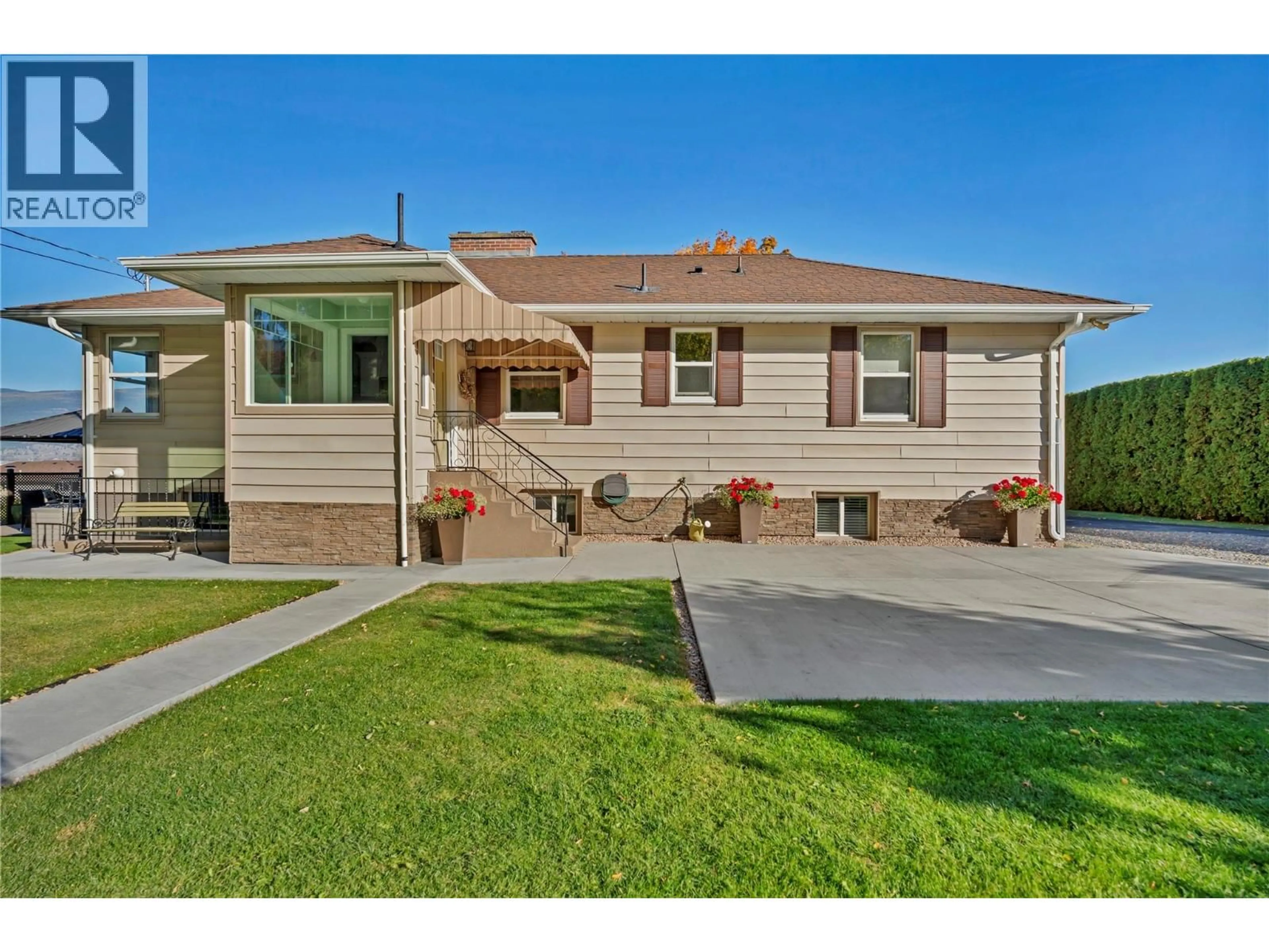 Home with vinyl exterior material, street for 1005 WEST BENCH DRIVE, Penticton British Columbia V2A8Y4