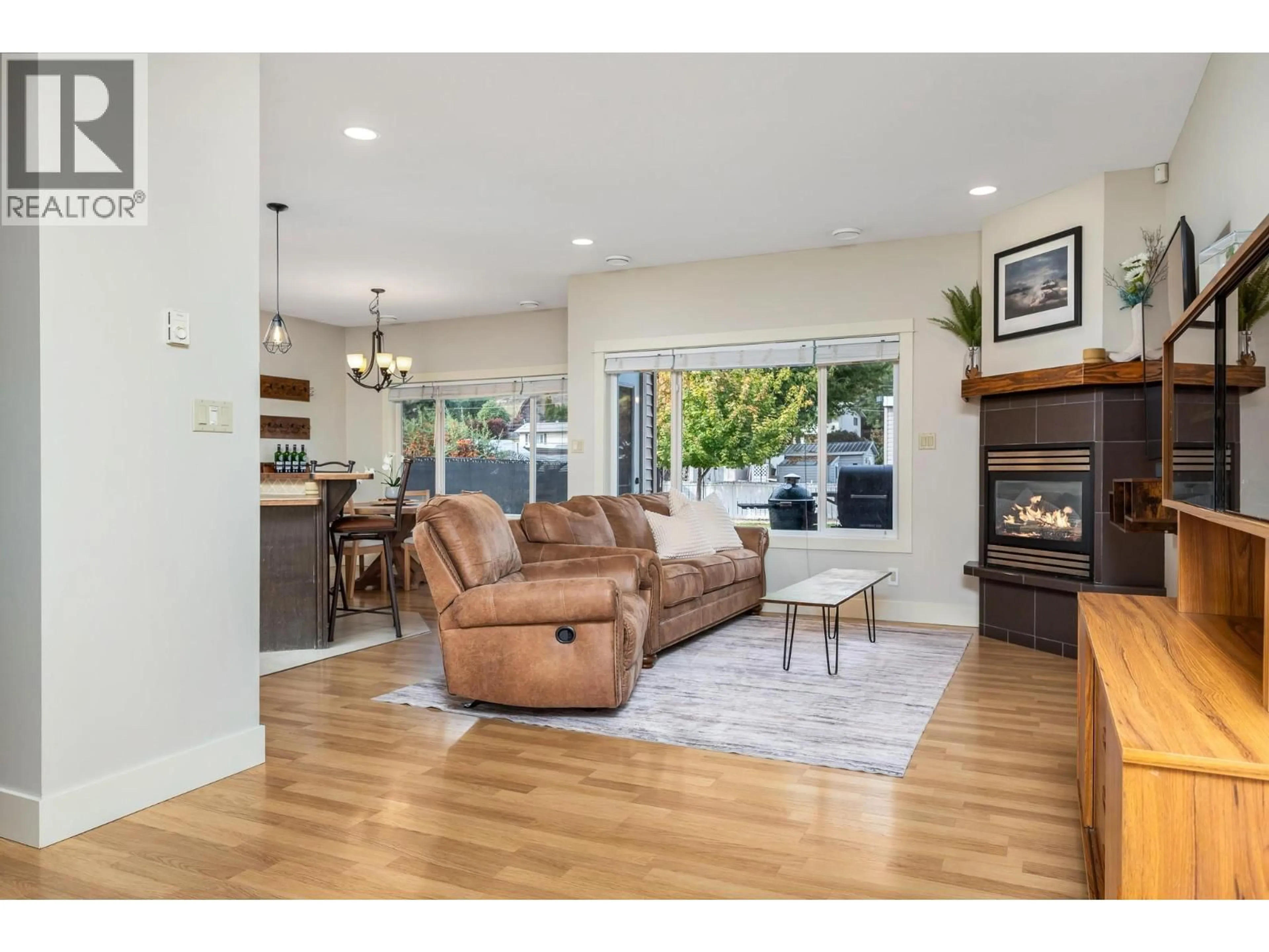 Living room with furniture, wood/laminate floor for 6665 TRONSON ROAD, Vernon British Columbia V1T4Y8