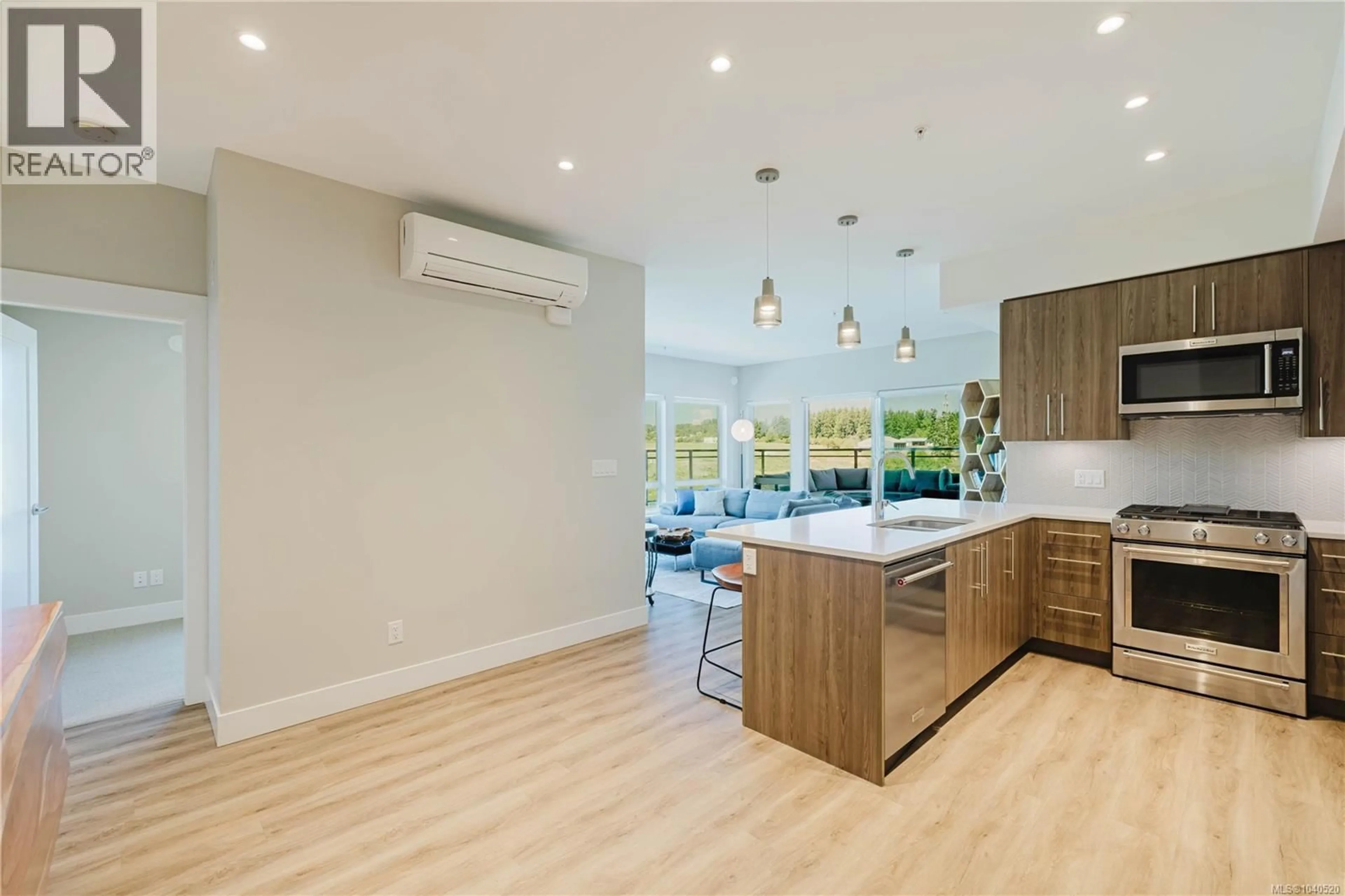 Open concept kitchen, wood/laminate floor for 501 - 2500 HACKETT CRESCENT, Central Saanich British Columbia V8M0C1