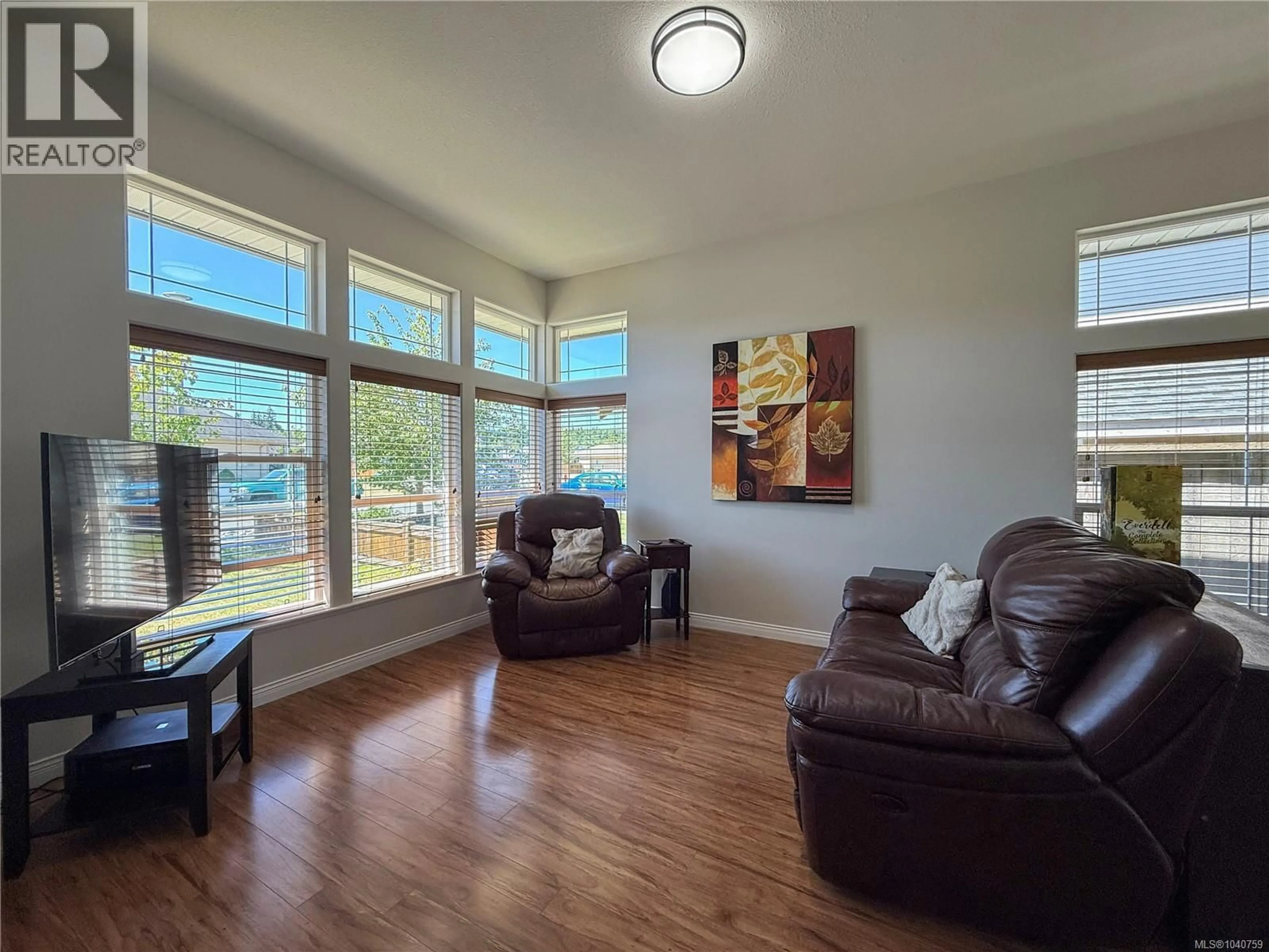 Living room with furniture, wood/laminate floor for 142 BRIND'AMOUR DRIVE, Campbell River British Columbia V9H0A2
