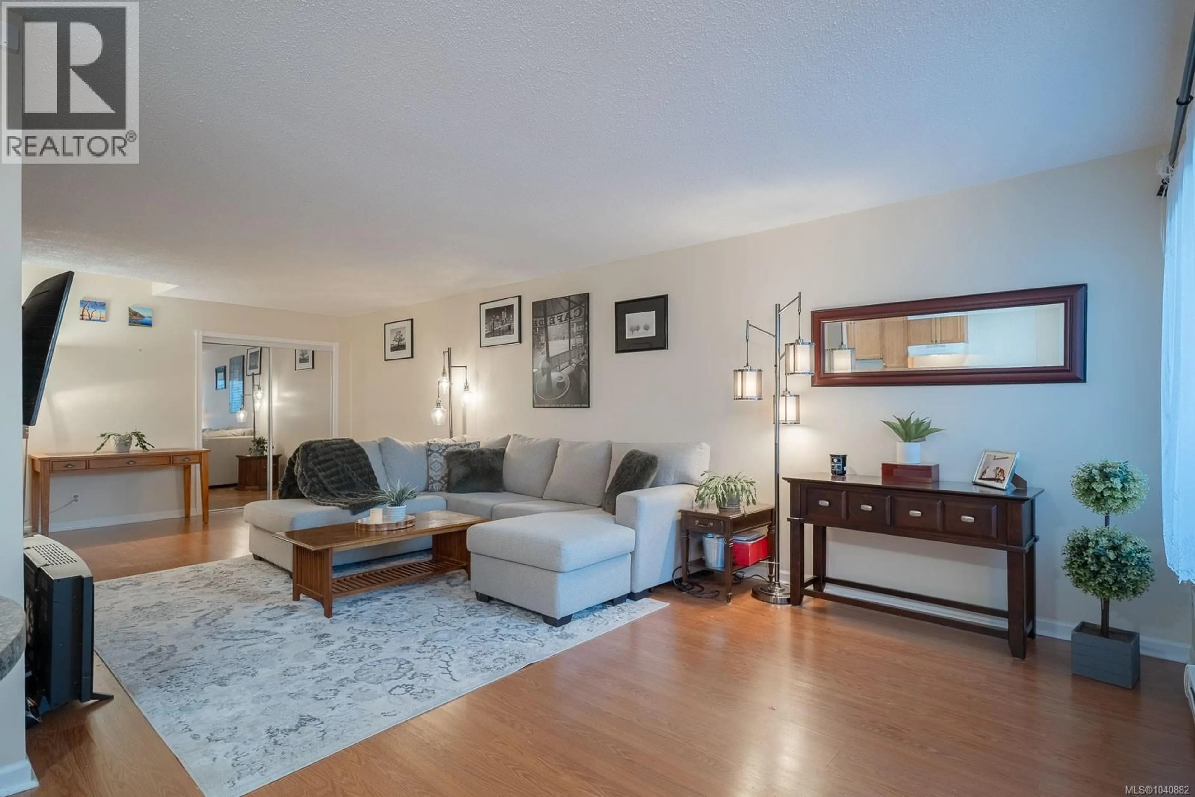 Living room with furniture, wood/laminate floor for 106B - 6231 BLUEBACK ROAD, Nanaimo British Columbia V9V1J3