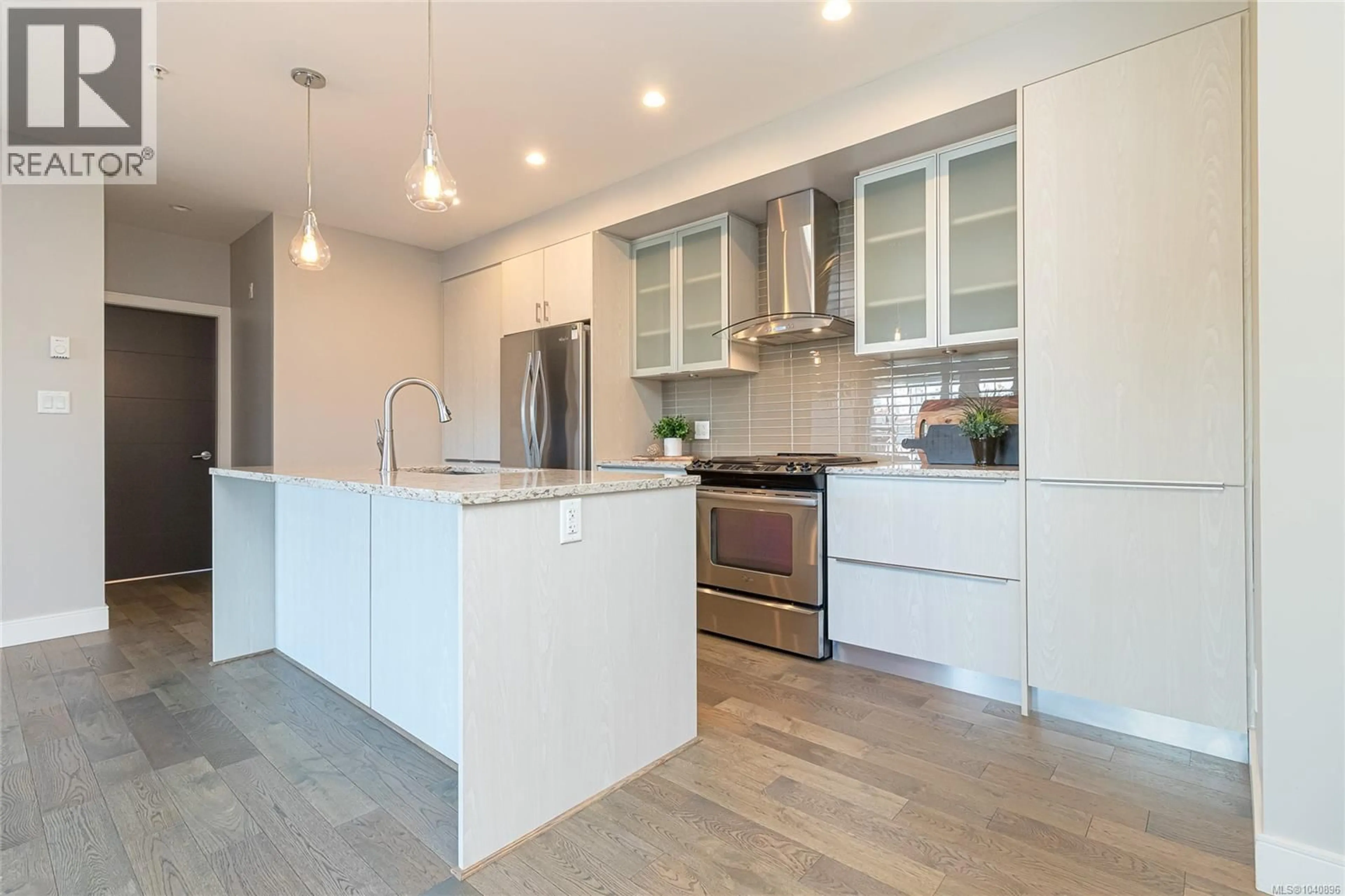 Open concept kitchen, wood/laminate floor for 308 - 1011 BURDETT AVENUE, Victoria British Columbia V8V3G9