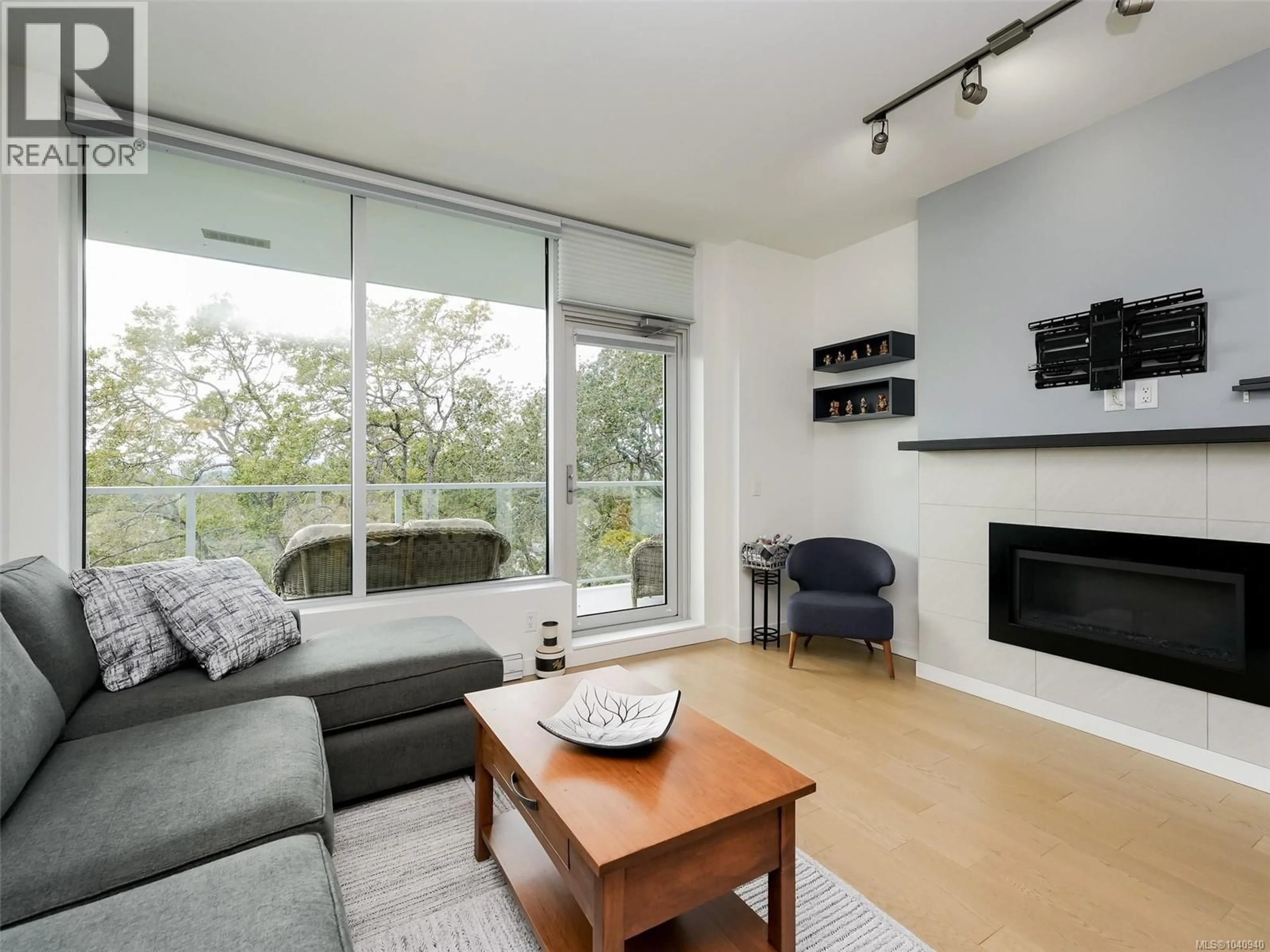 Living room with furniture, wood/laminate floor for 603 - 4009 RAINBOW HILL LANE, Saanich British Columbia V8X0B3
