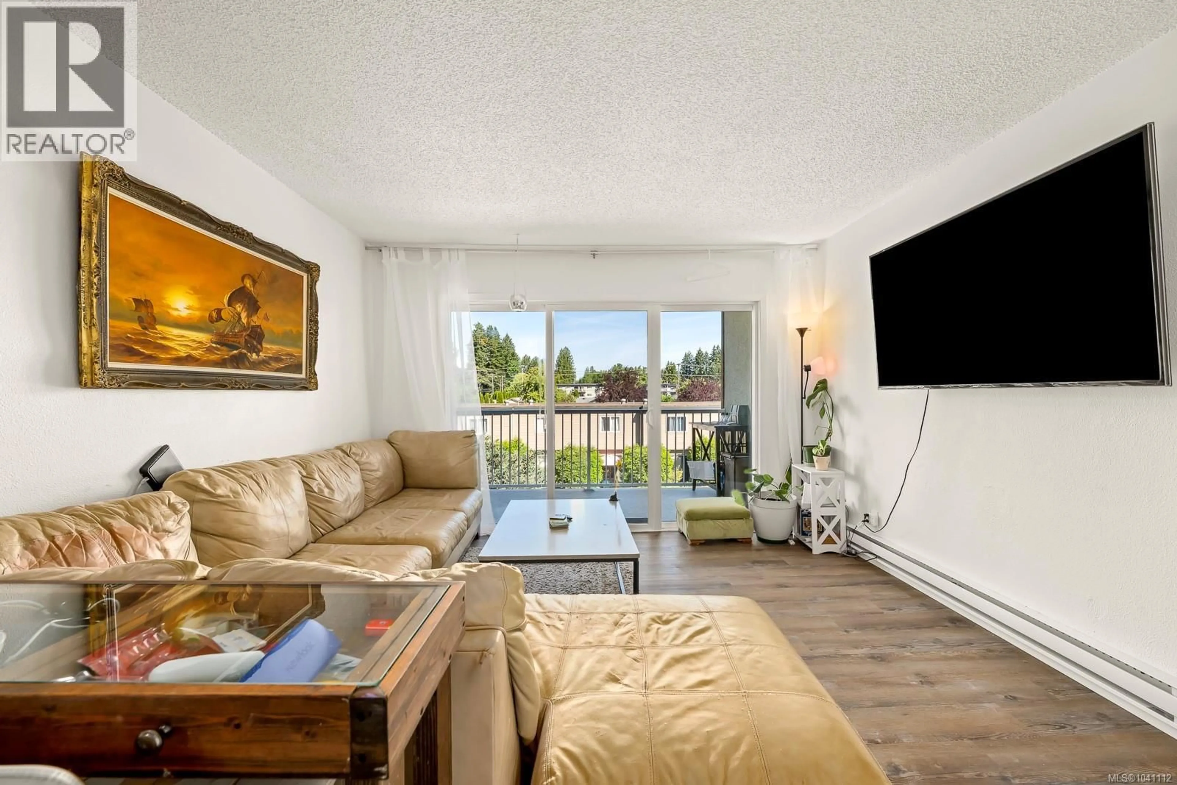Living room with furniture, wood/laminate floor for 301 - 1130 WILLEMAR AVENUE, Courtenay British Columbia V9N3L9