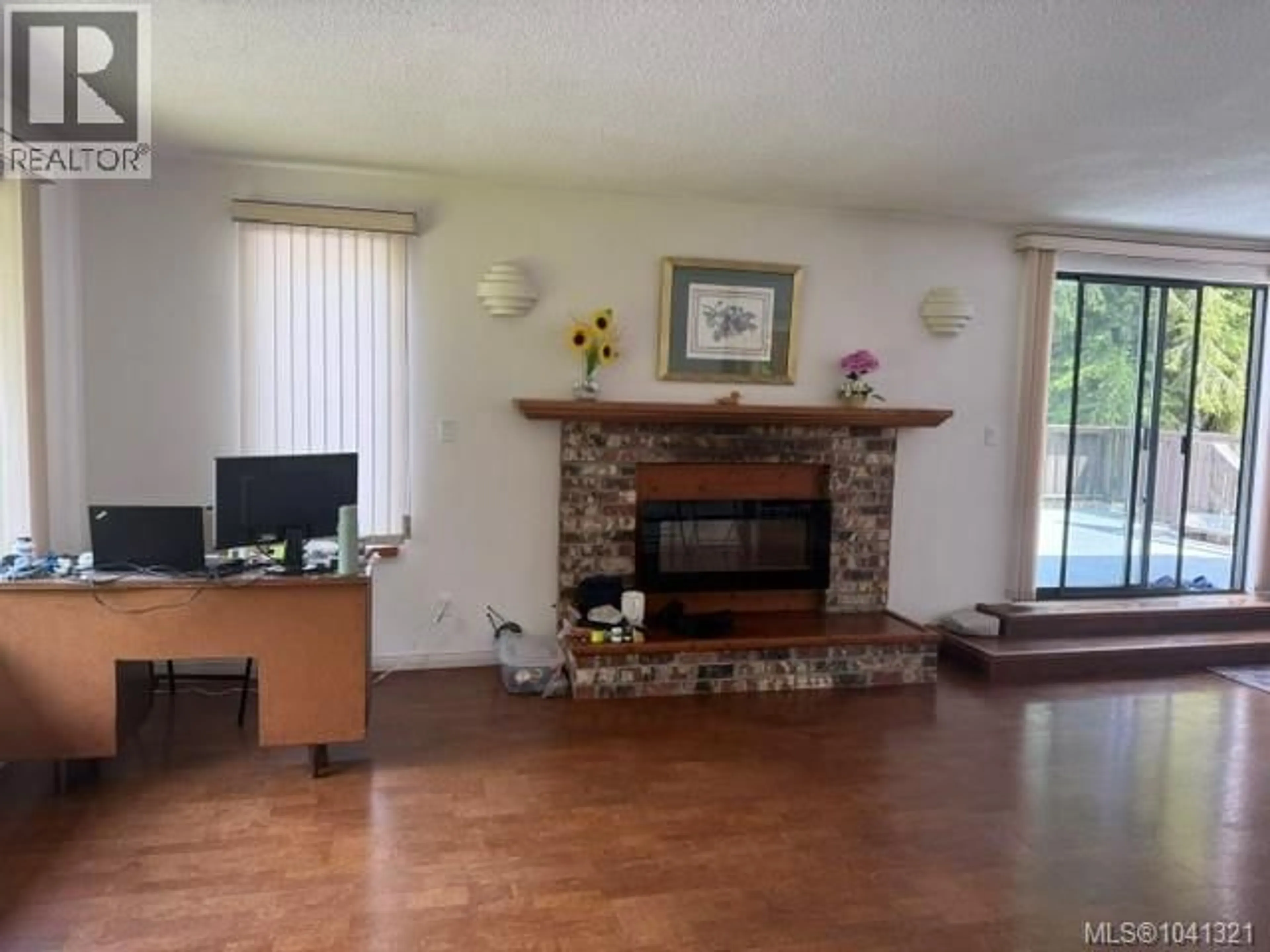 Living room with furniture, wood/laminate floor for 8335 CAMELOT ROAD, Port Hardy British Columbia V0N2P0
