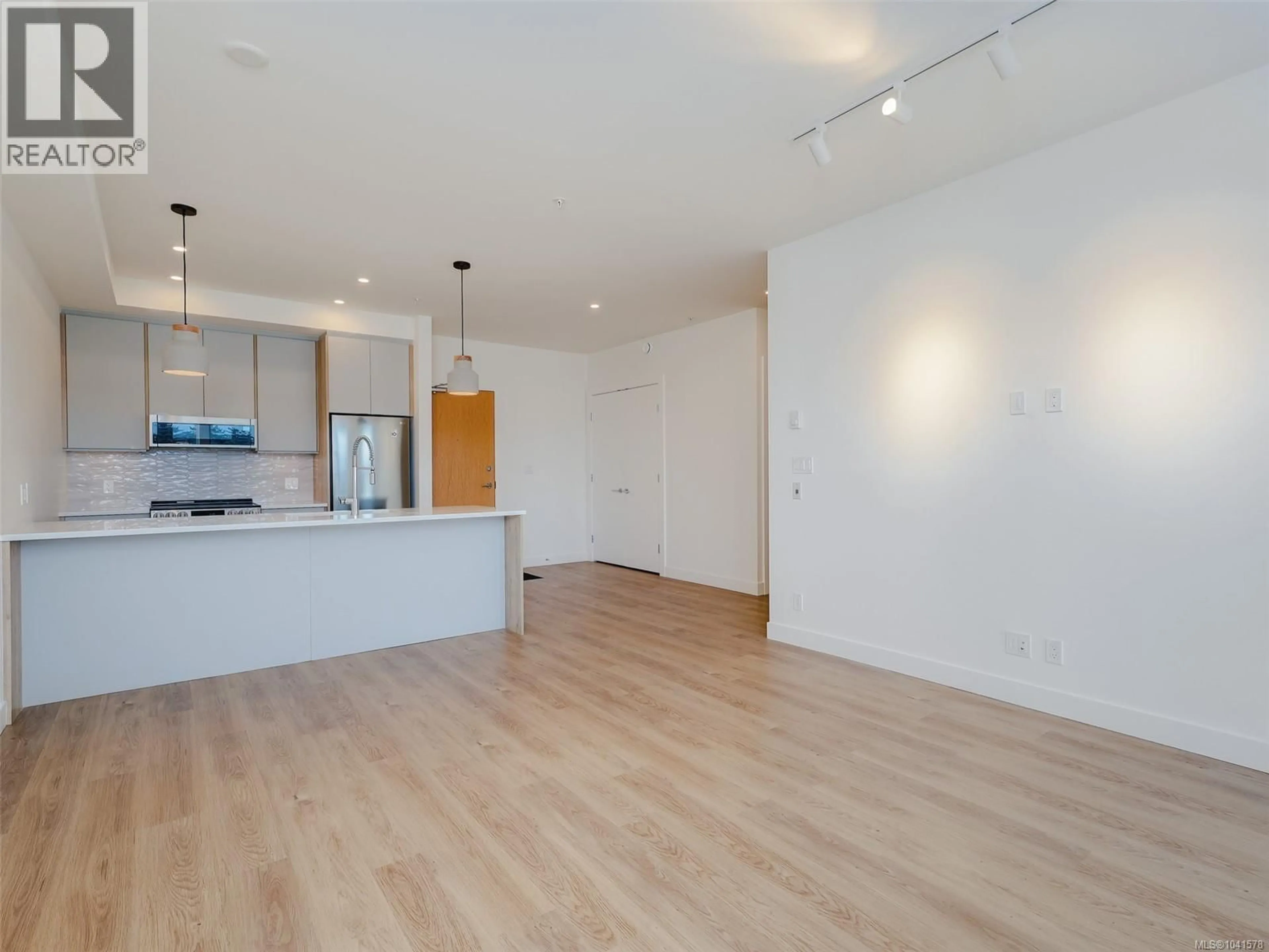 Open concept kitchen, wood/laminate floor for 403 - 757 TYEE ROAD, Victoria British Columbia V9A7P7
