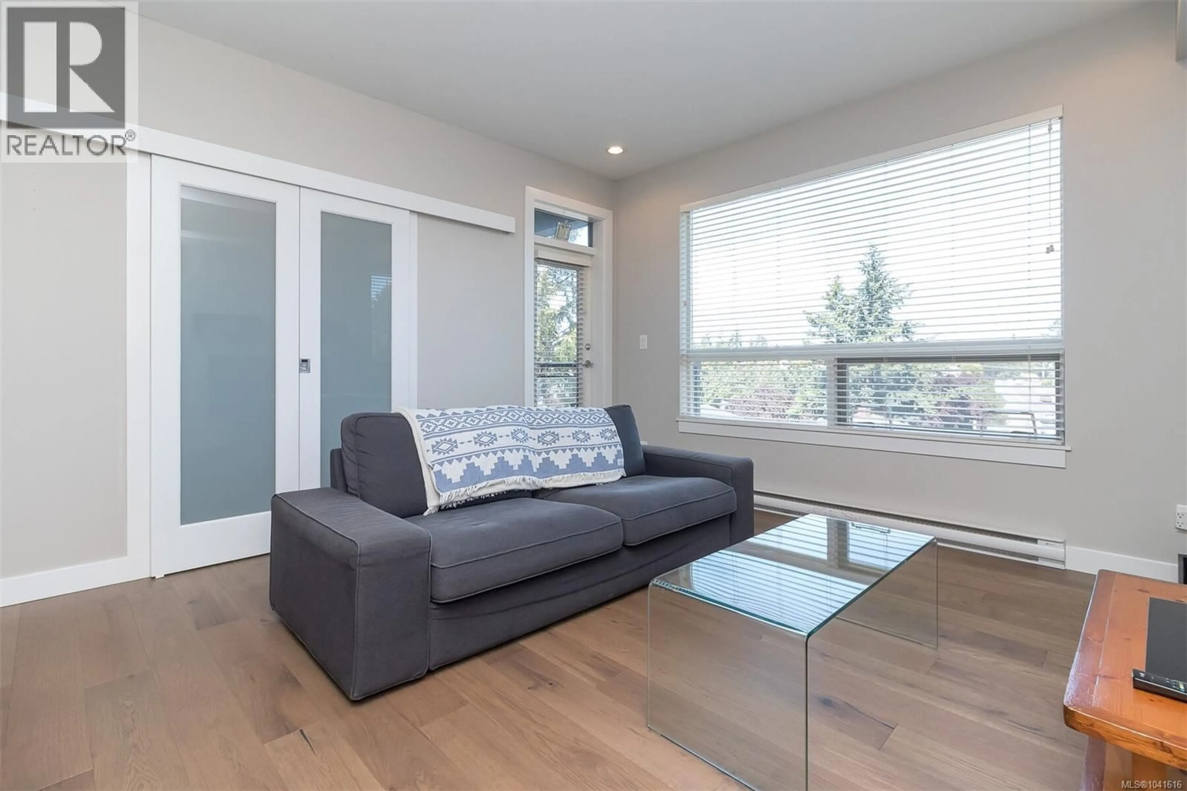 Living room with furniture, wood/laminate floor for 203 - 1008 TILLICUM ROAD, Esquimalt British Columbia V9A1Z8