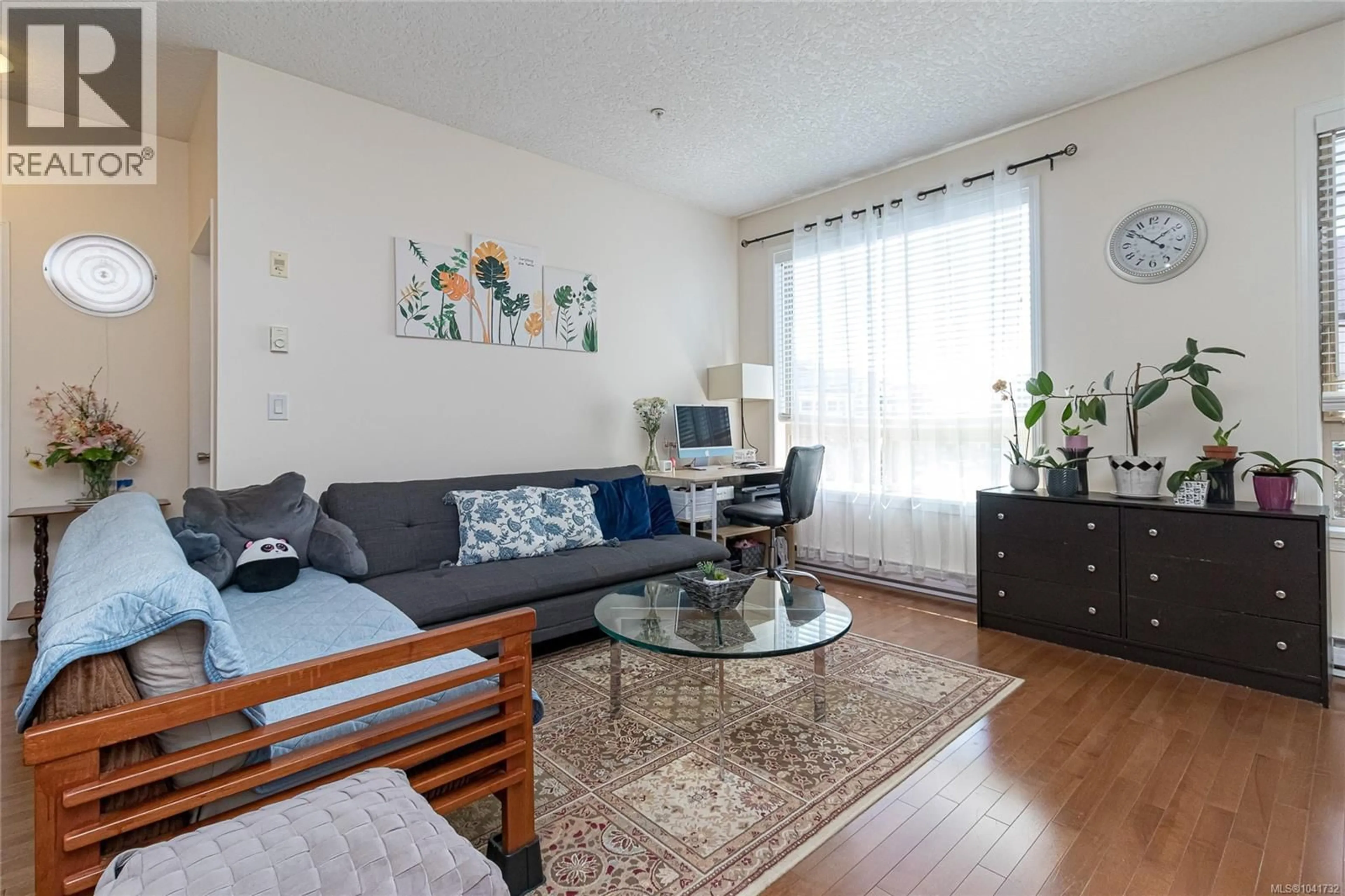 Living room with furniture, wood/laminate floor for 401 - 825 GOLDSTREAM AVENUE, Langford British Columbia V9B0C3