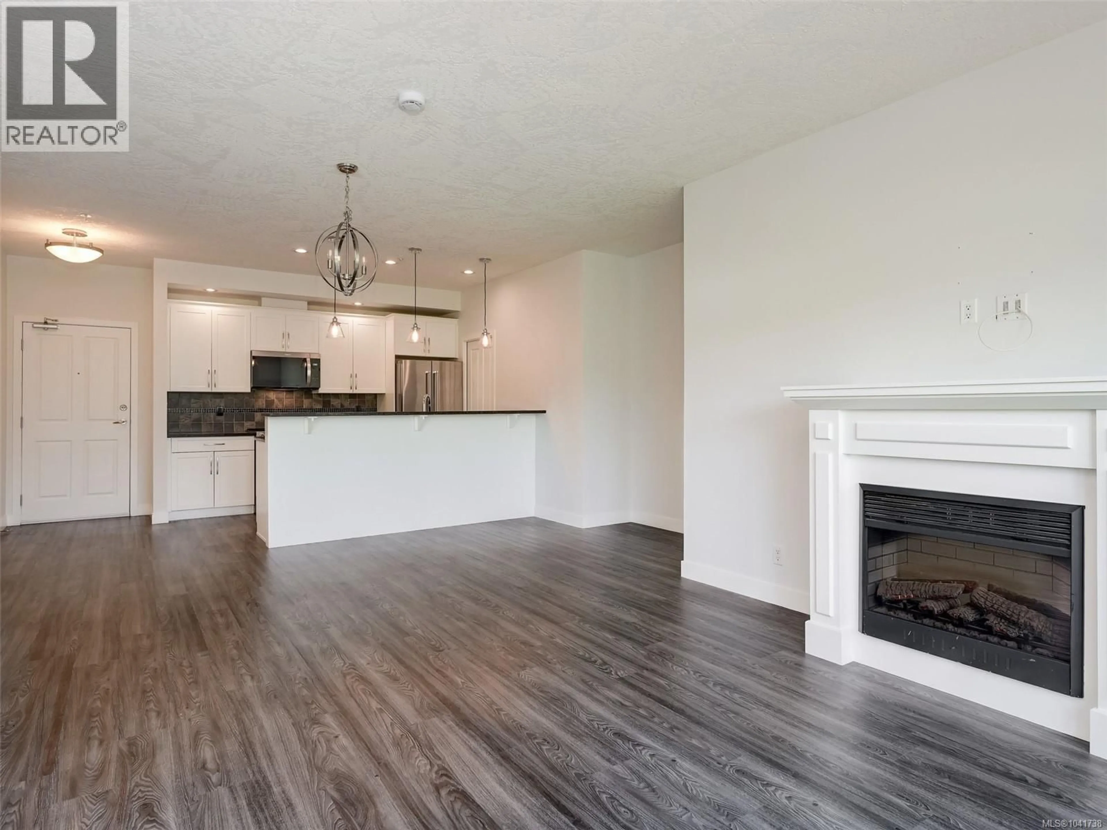 Open concept kitchen, wood/laminate floor for 402 - 623 TREANOR AVENUE, Langford British Columbia V9B0B1