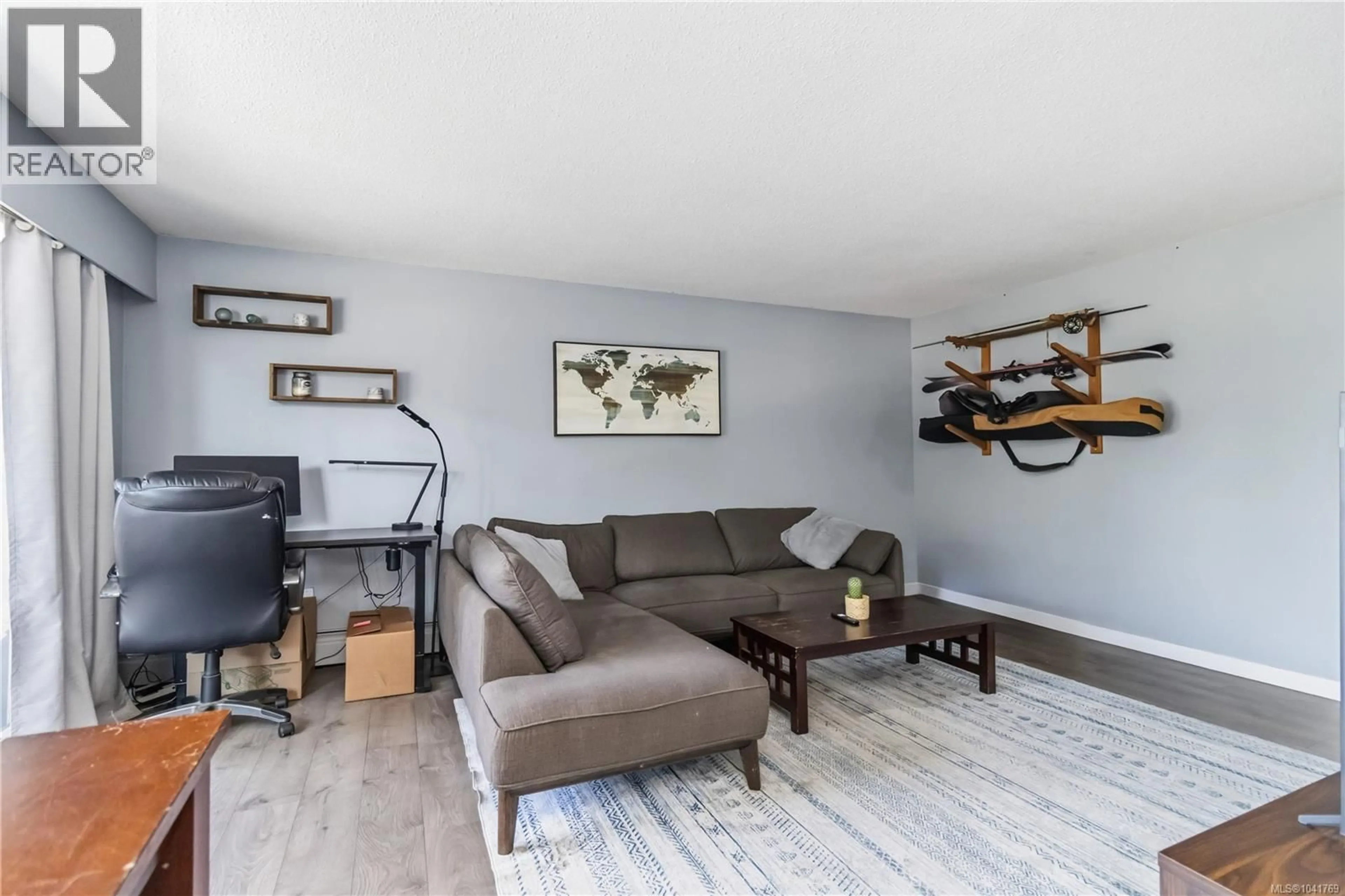 Living room with furniture, wood/laminate floor for 203 - 3800 QUADRA STREET, Saanich British Columbia V8R5G4