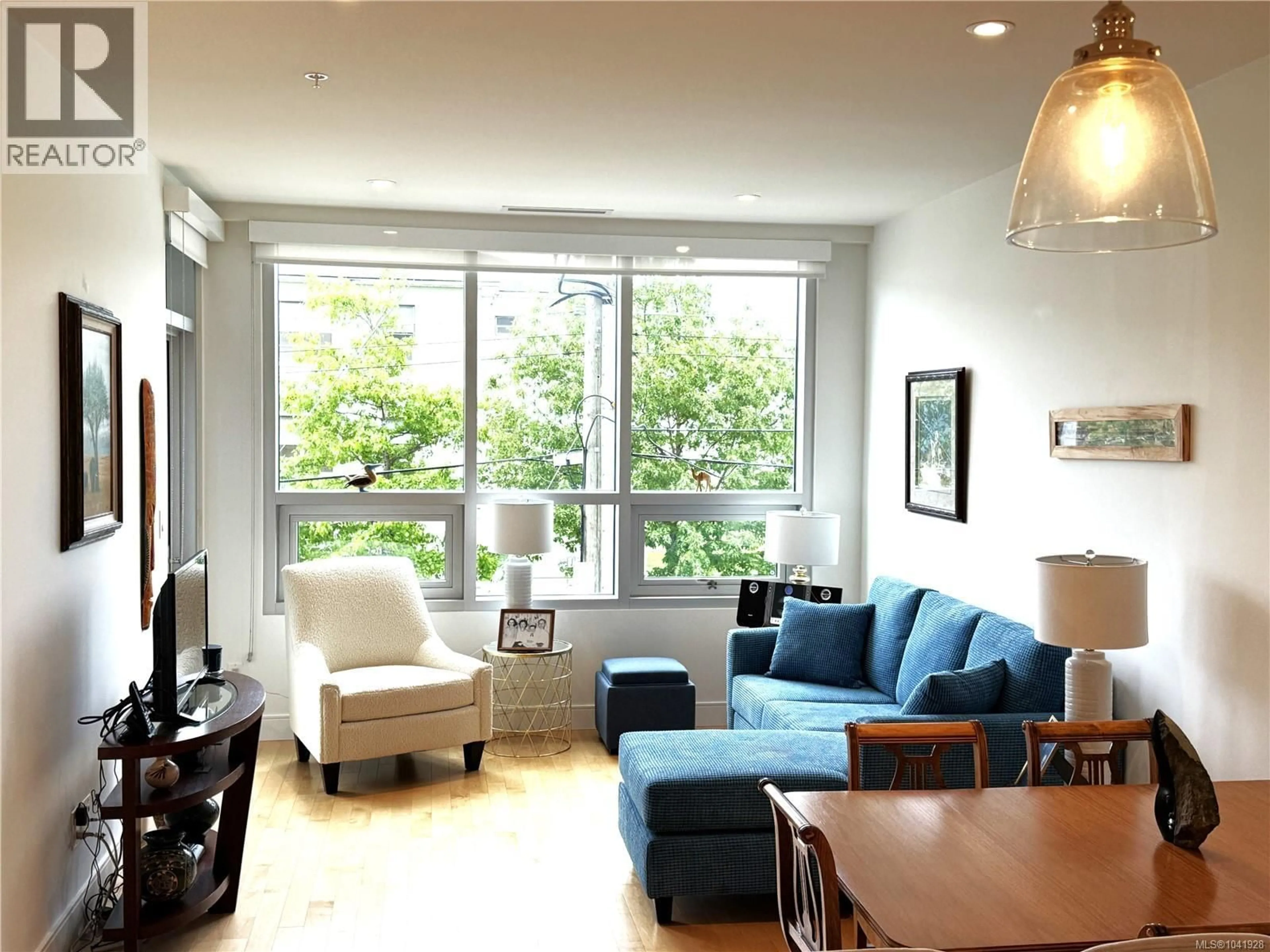 Living room with furniture, wood/laminate floor for 204 - 916 LYALL STREET, Esquimalt British Columbia V9A5E6