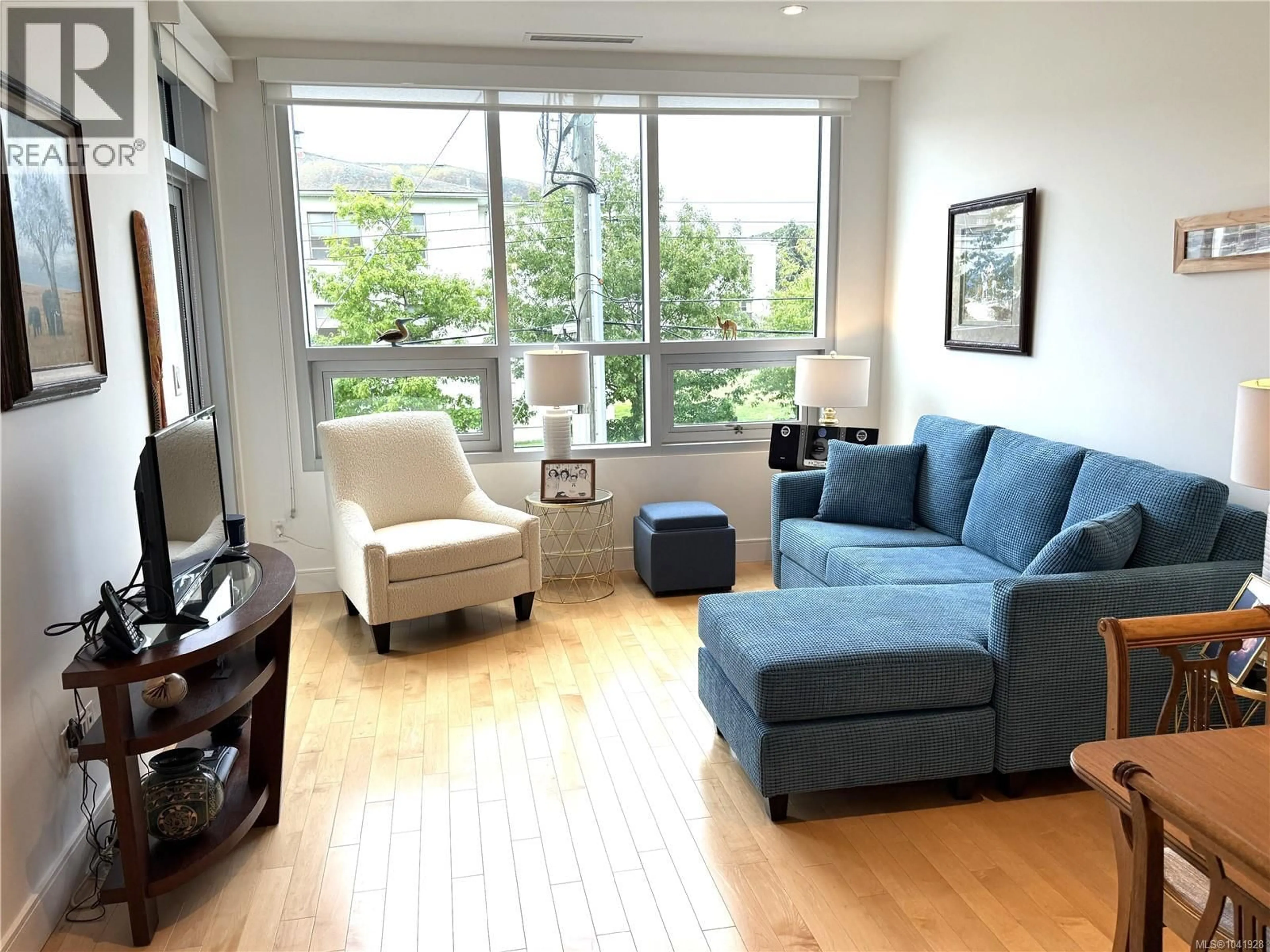 Living room with furniture, wood/laminate floor for 204 - 916 LYALL STREET, Esquimalt British Columbia V9A5E6