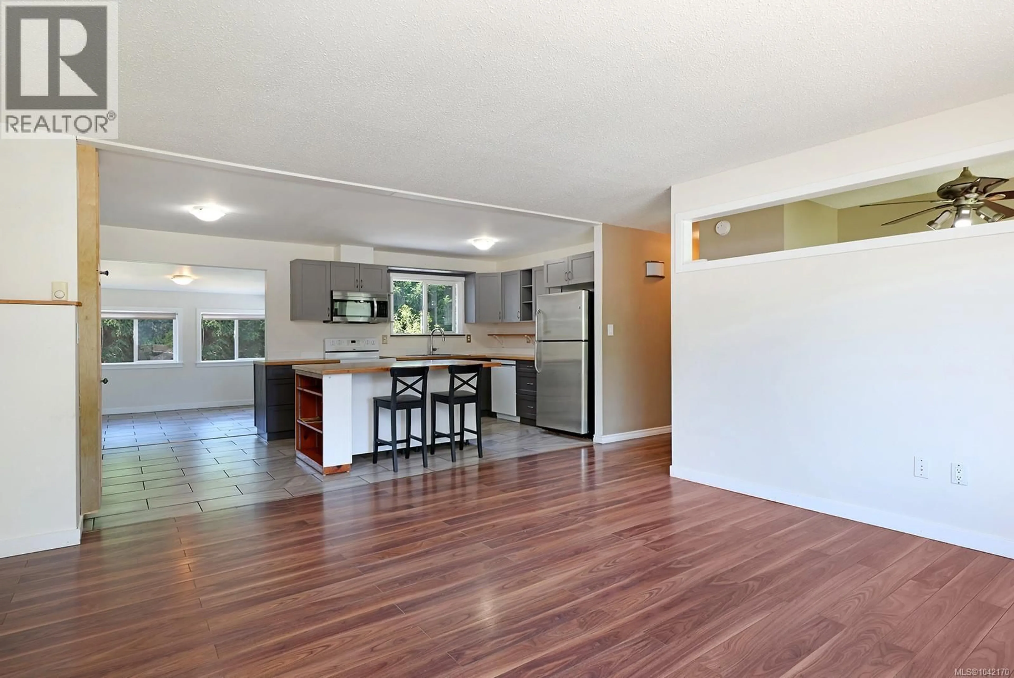 Open concept kitchen, wood/laminate floor for 2057 HUMMINGBIRD PLACE, Comox British Columbia V9M2A2