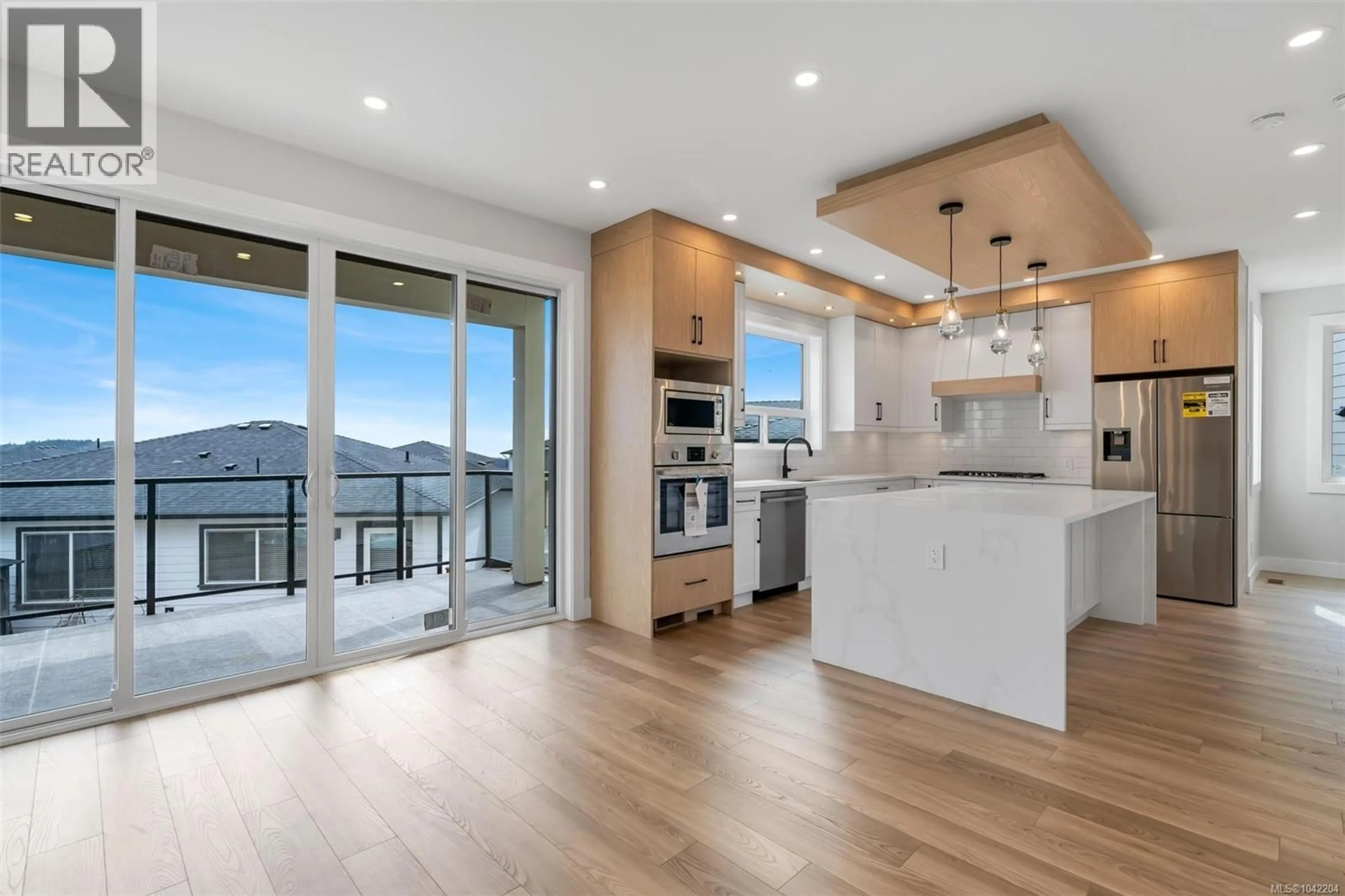 Open concept kitchen, wood/laminate floor for 1358 SANDSTONE LANE, Langford British Columbia V9B7A2