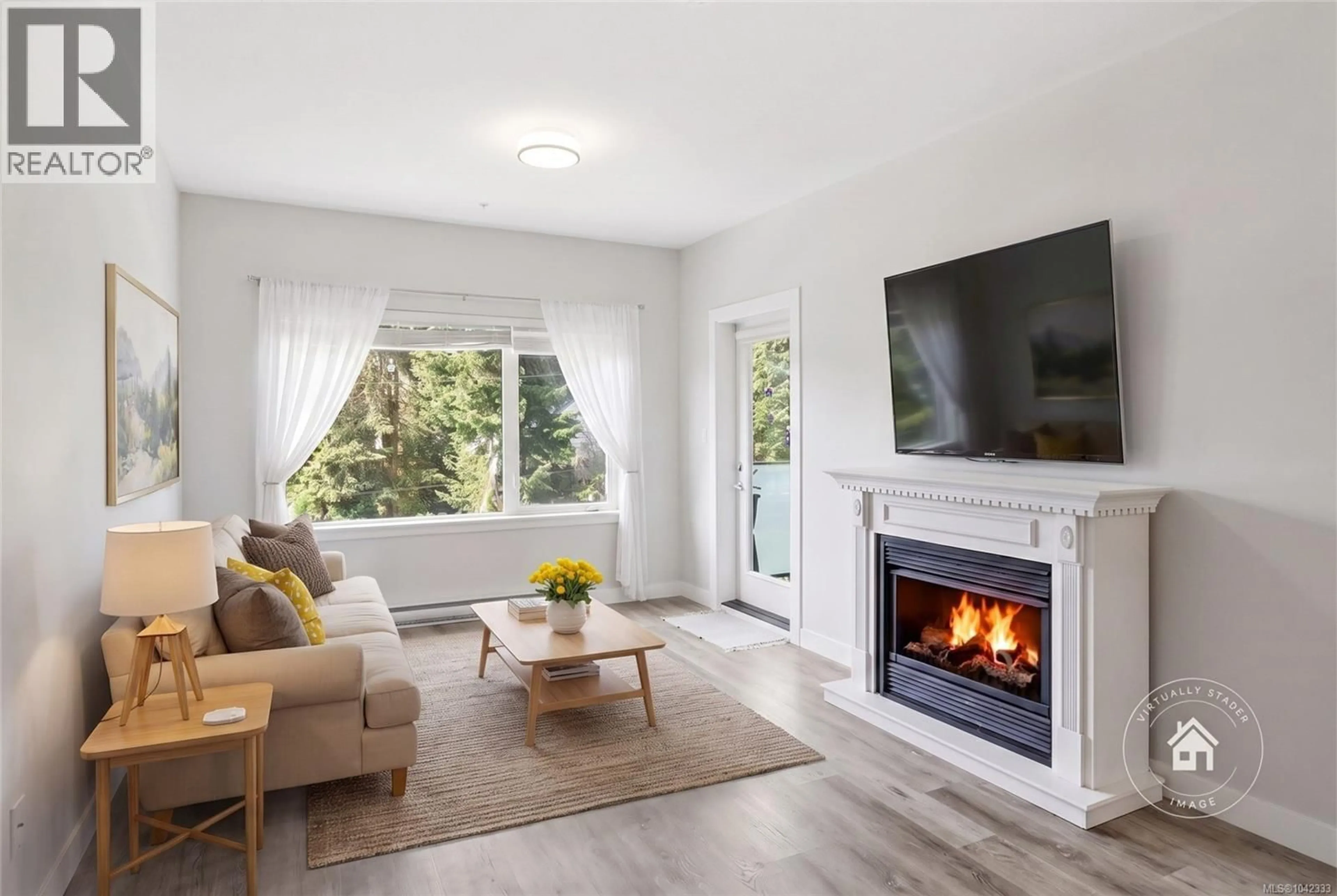 Living room with furniture, wood/laminate floor for 308 - 20 BARSBY AVENUE, Nanaimo British Columbia V9R0K4