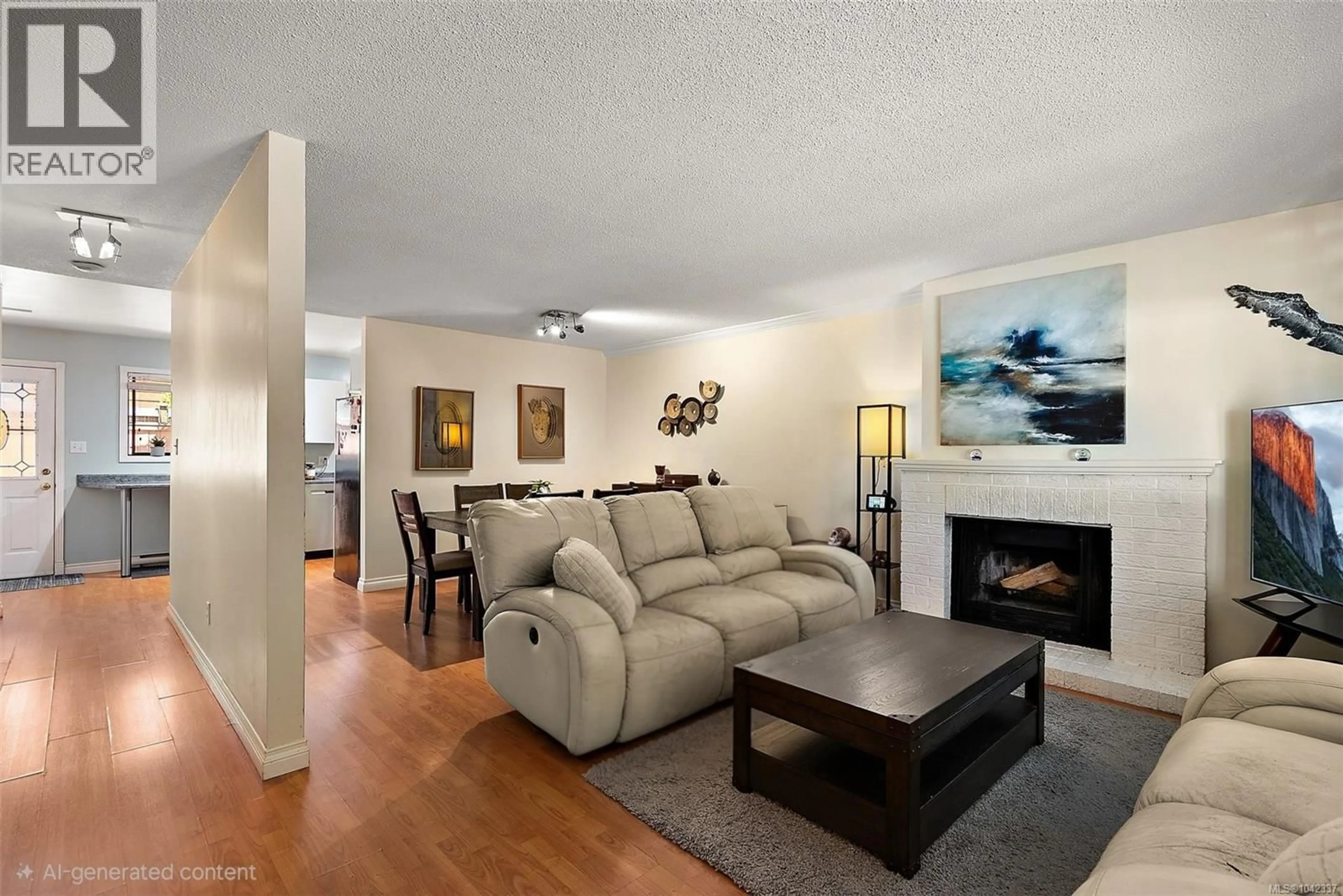 Living room with furniture, wood/laminate floor for 113 - 2763 JACKLIN ROAD, Langford British Columbia V9B1B1