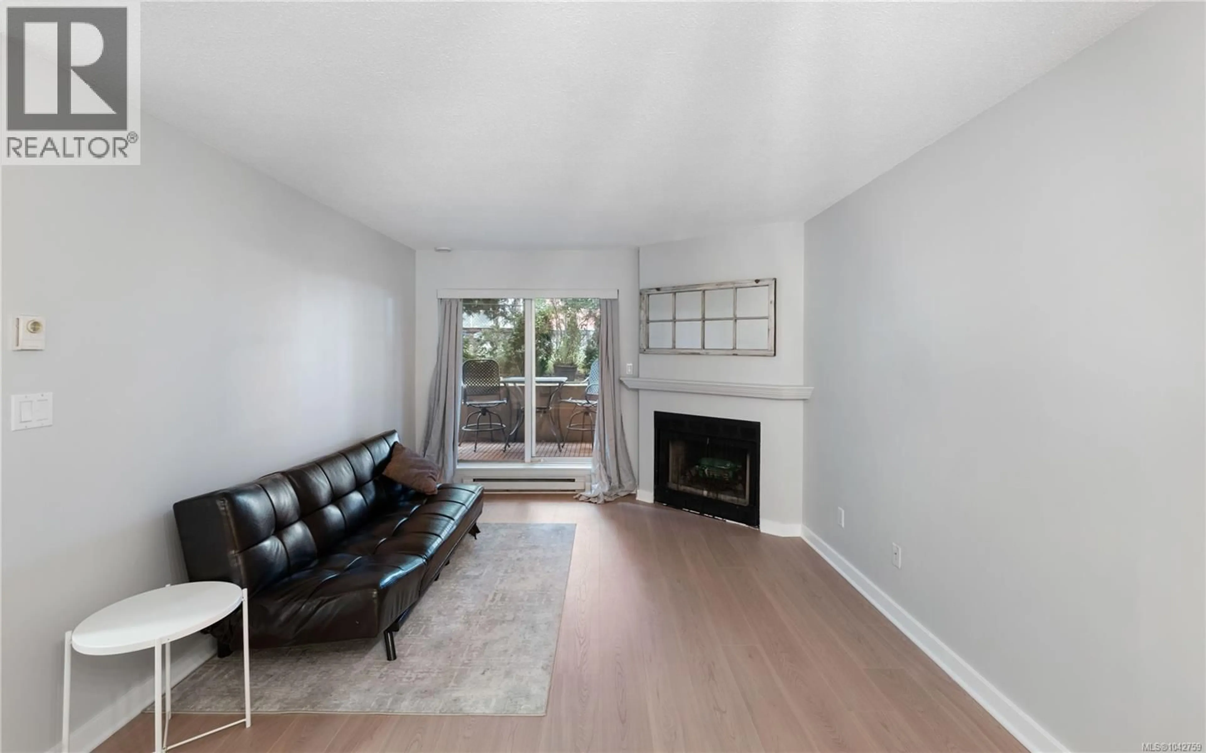 Living room with furniture, wood/laminate floor for 105 - 2520 WARK STREET, Victoria British Columbia V8T5G6