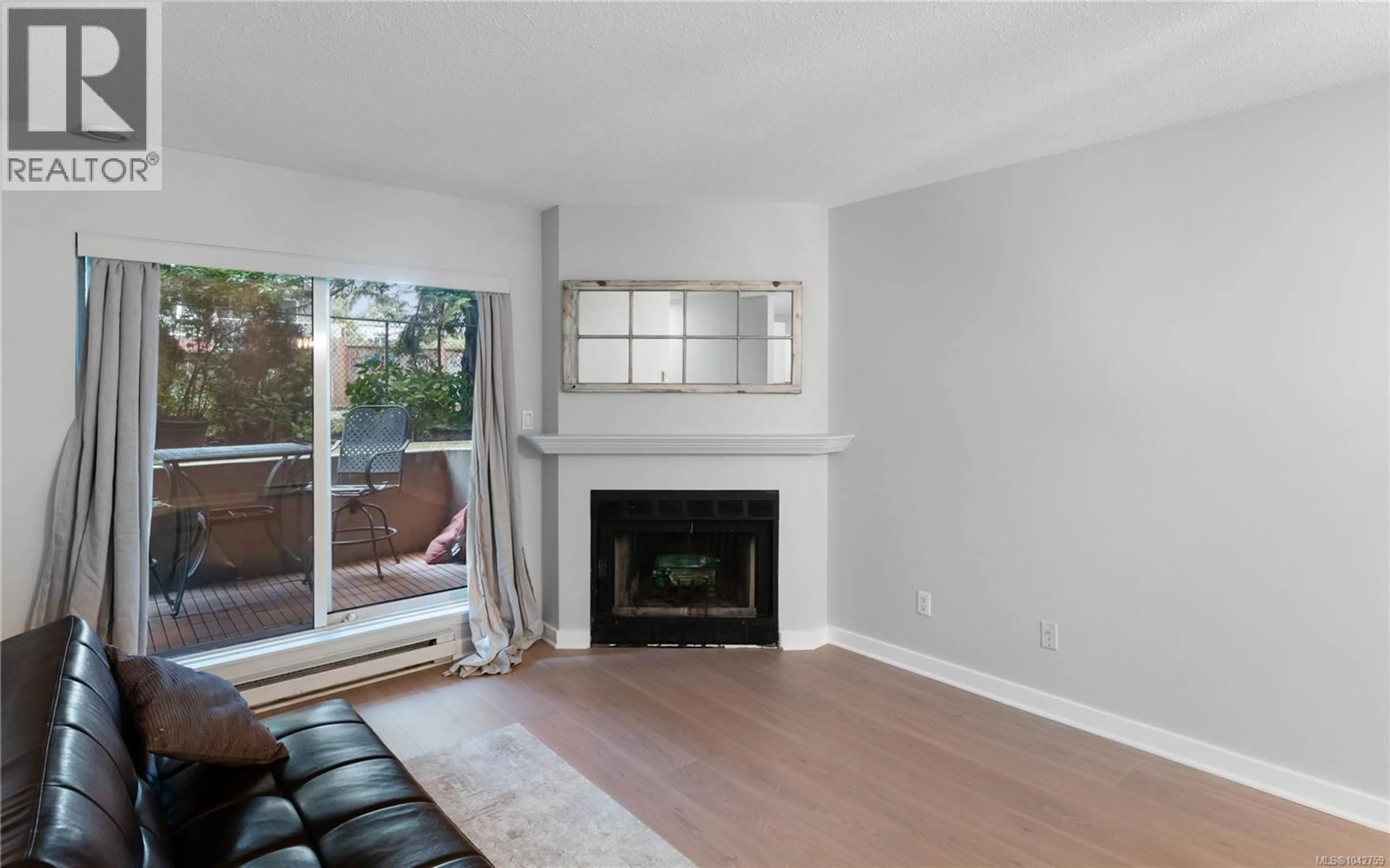 Living room with furniture, wood/laminate floor for 105 - 2520 WARK STREET, Victoria British Columbia V8T5G6
