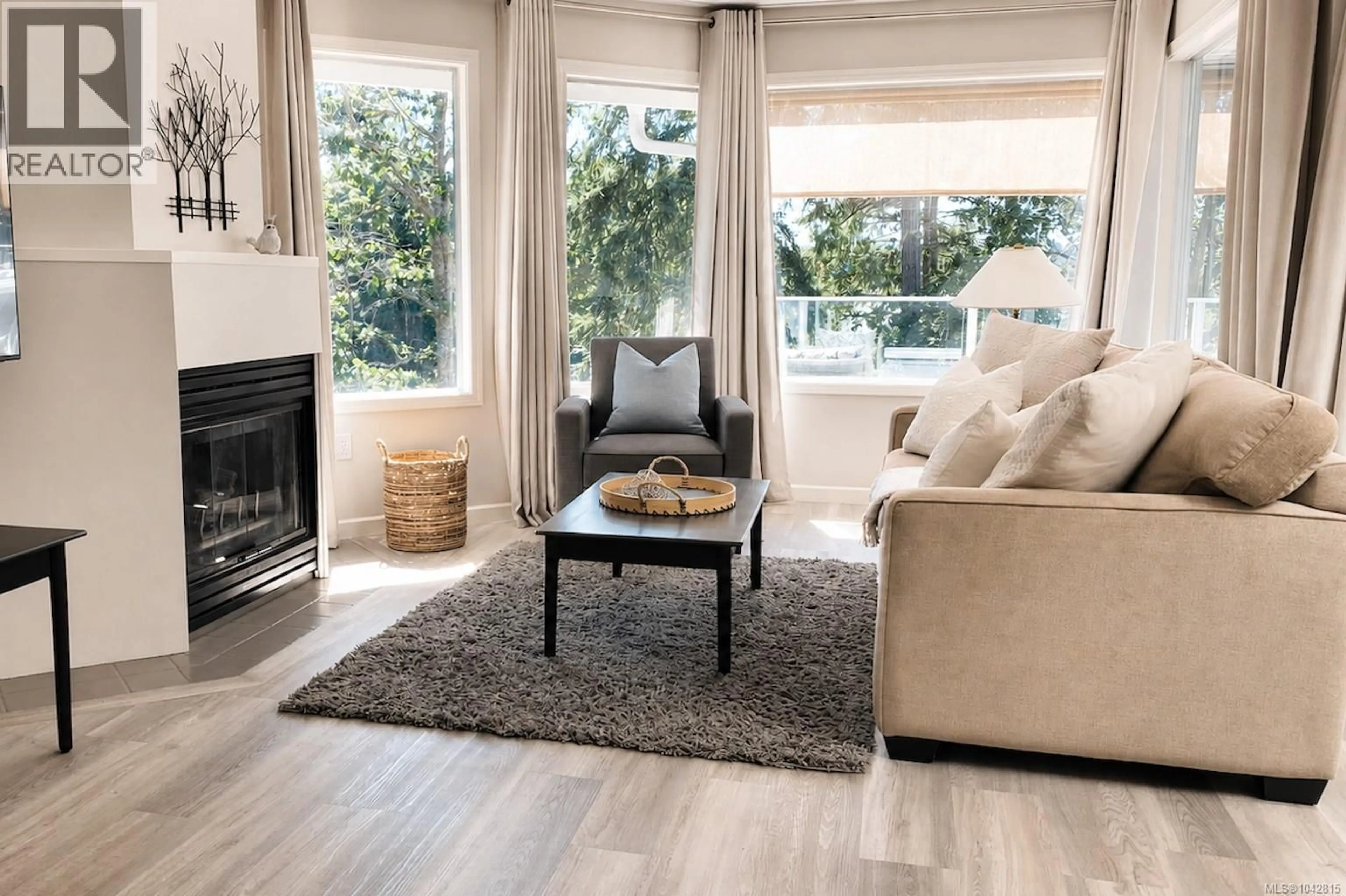 Living room with furniture, wood/laminate floor for 322 - 1600 STROULGER ROAD, Nanoose Bay British Columbia V9P9B7