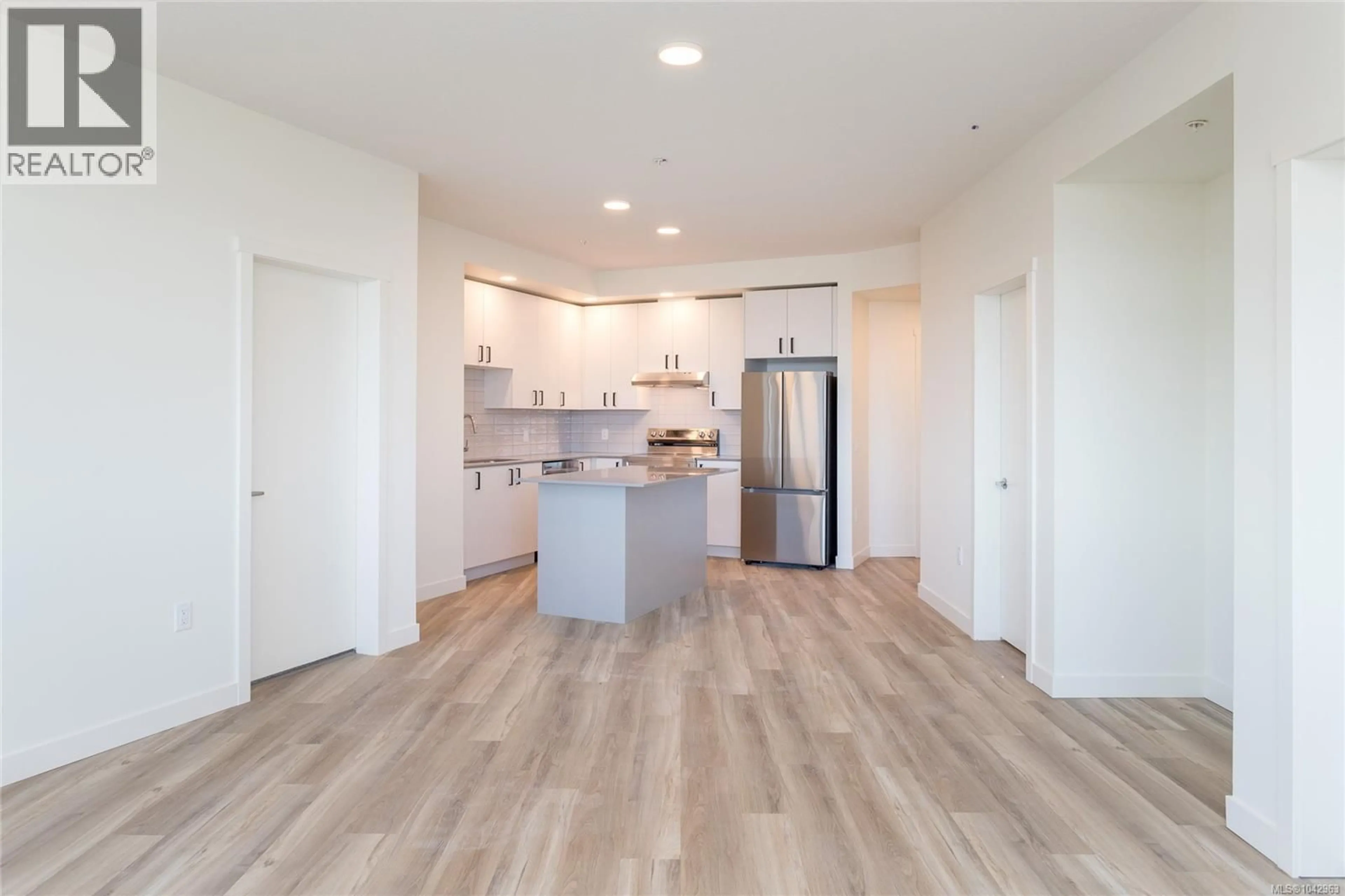Open concept kitchen, wood/laminate floor for 314 - 2390 CITY GATE BOULEVARD, Langford British Columbia V9B7E8