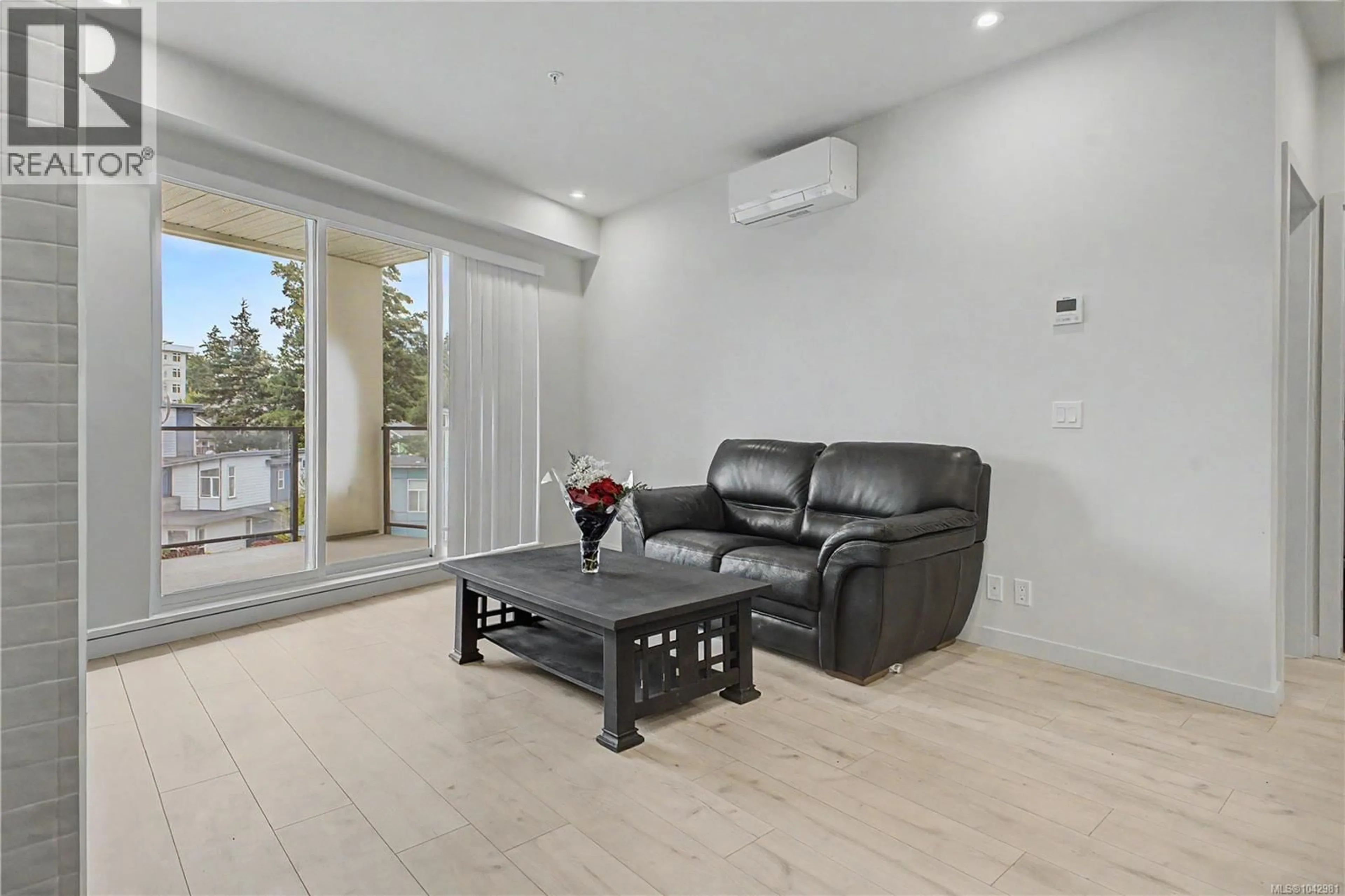 Living room with furniture, wood/laminate floor for 304 - 947 WHIRLAWAY CRESCENT, Langford British Columbia V9B6Z9