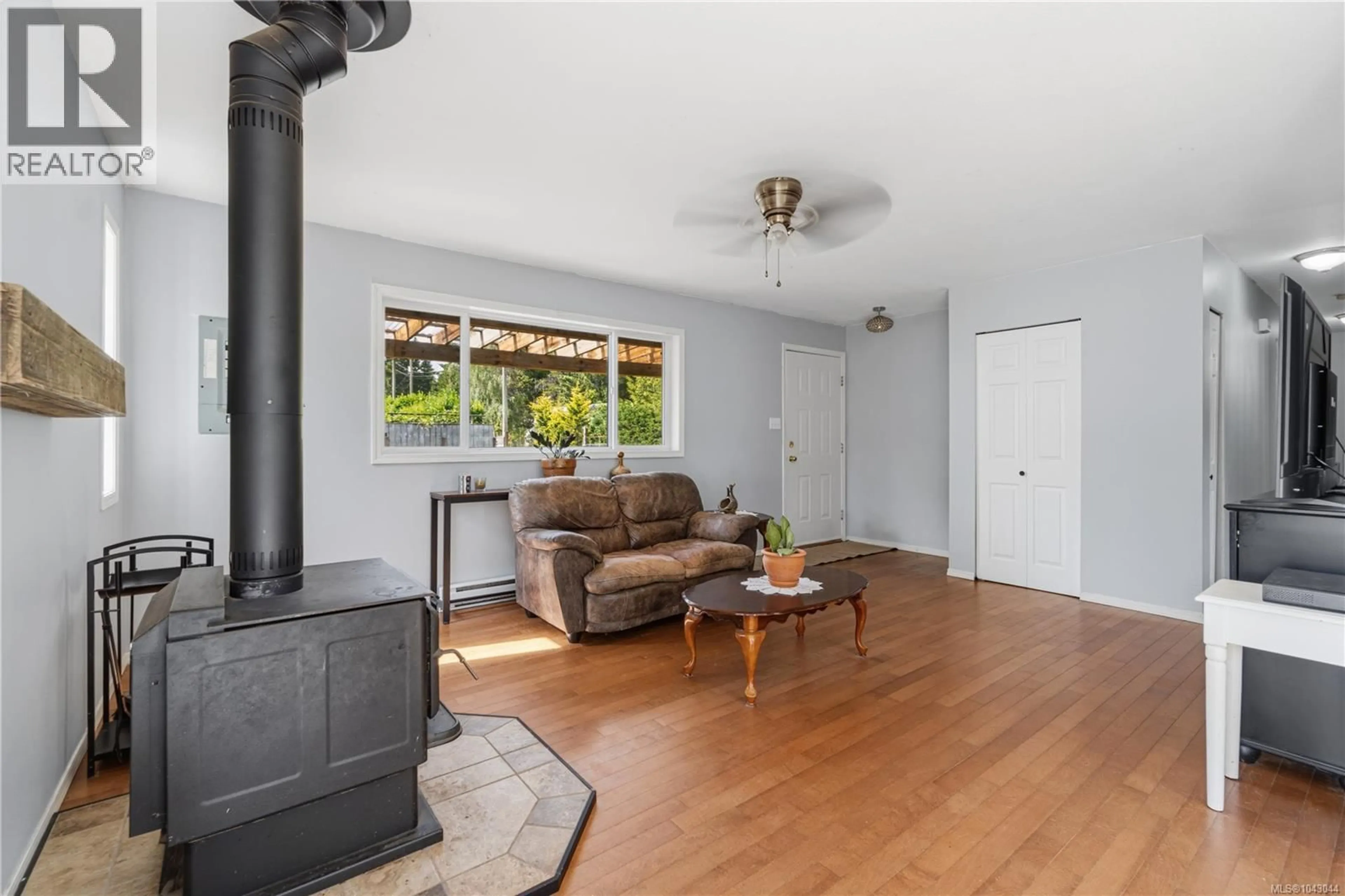Living room with furniture, wood/laminate floor for 2955 THISTLEDOWN ROAD, Qualicum Beach British Columbia V9K2A2