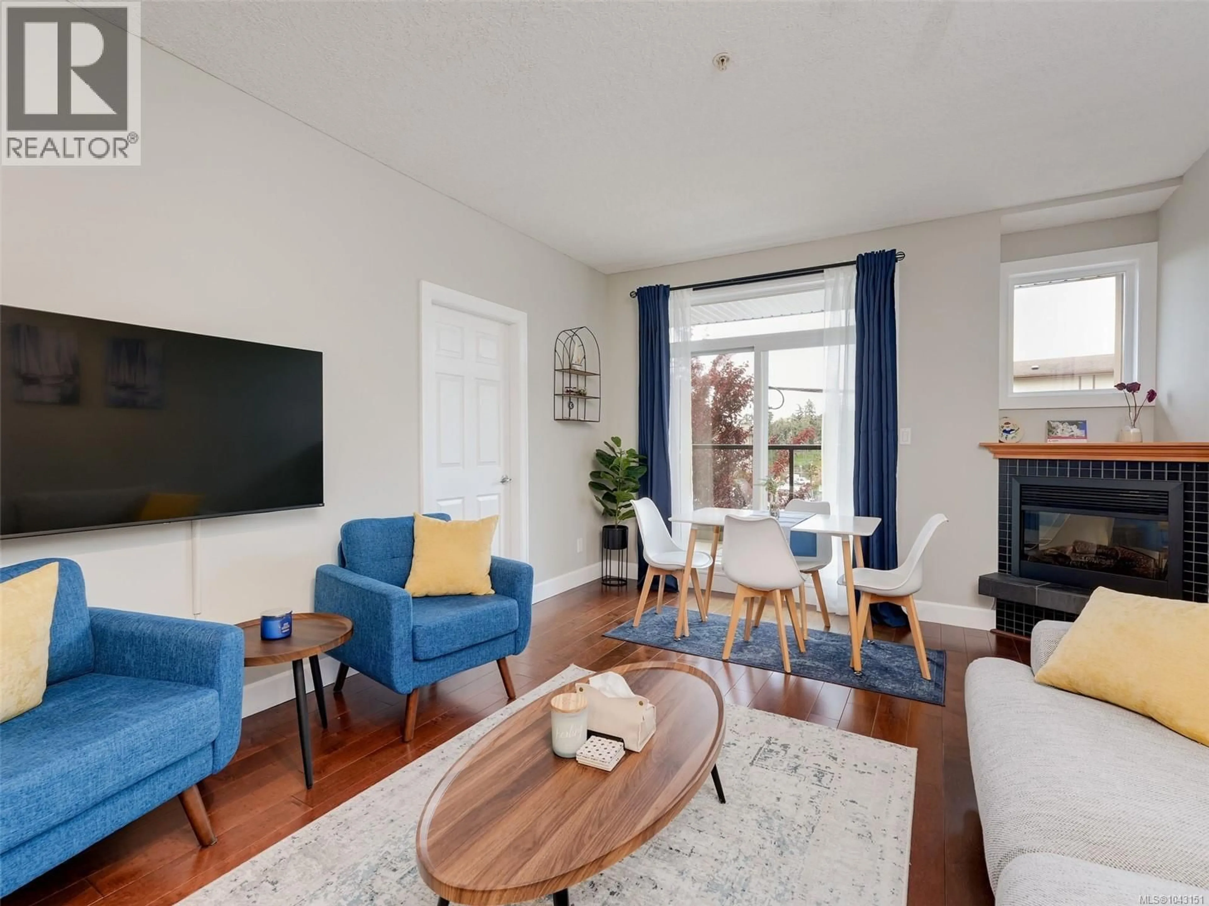 Living room with furniture, wood/laminate floor for 204 - 76 GORGE ROAD WEST, Saanich British Columbia V9A1M1