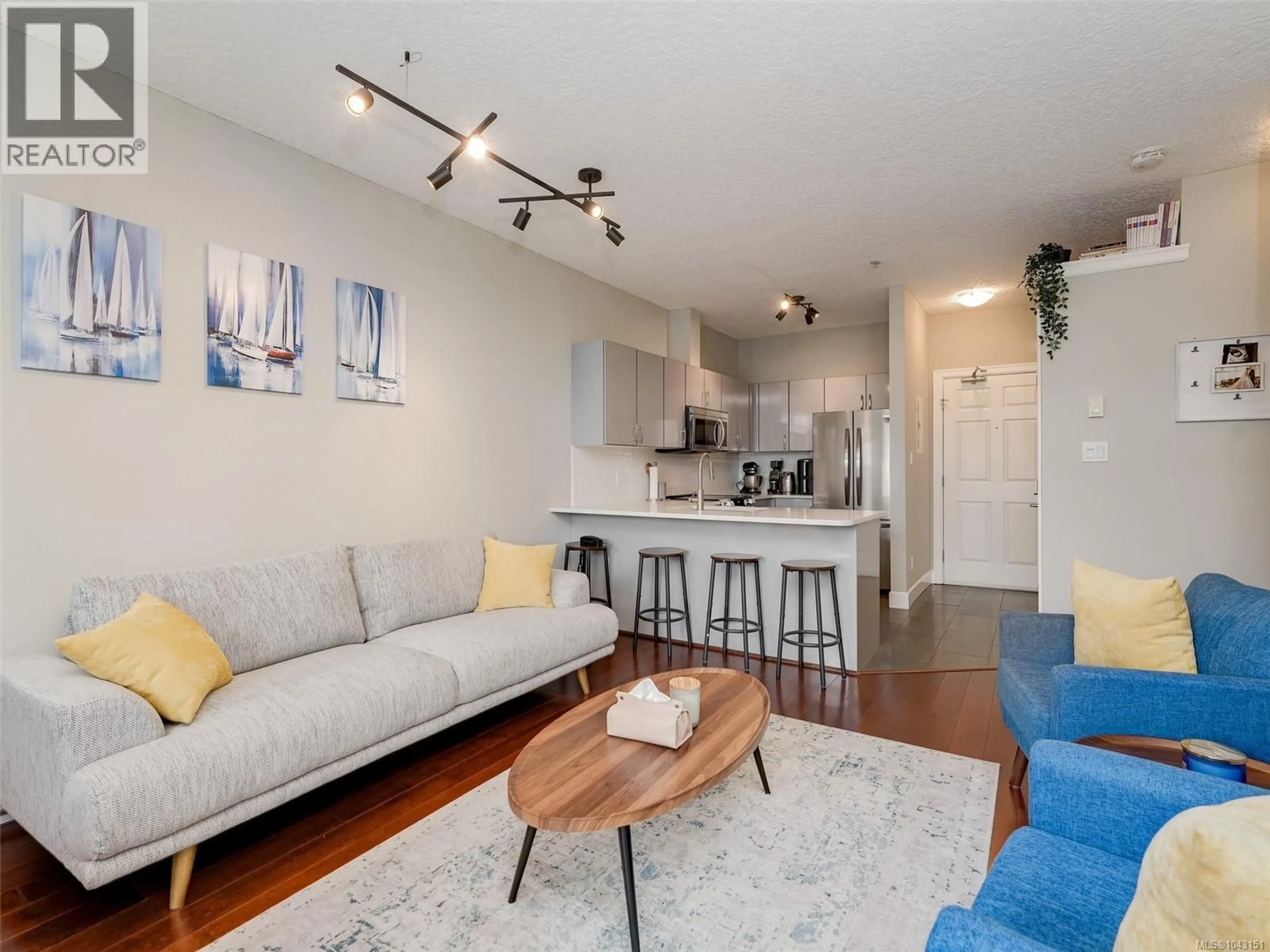 Living room with furniture, wood/laminate floor for 204 - 76 GORGE ROAD WEST, Saanich British Columbia V9A1M1