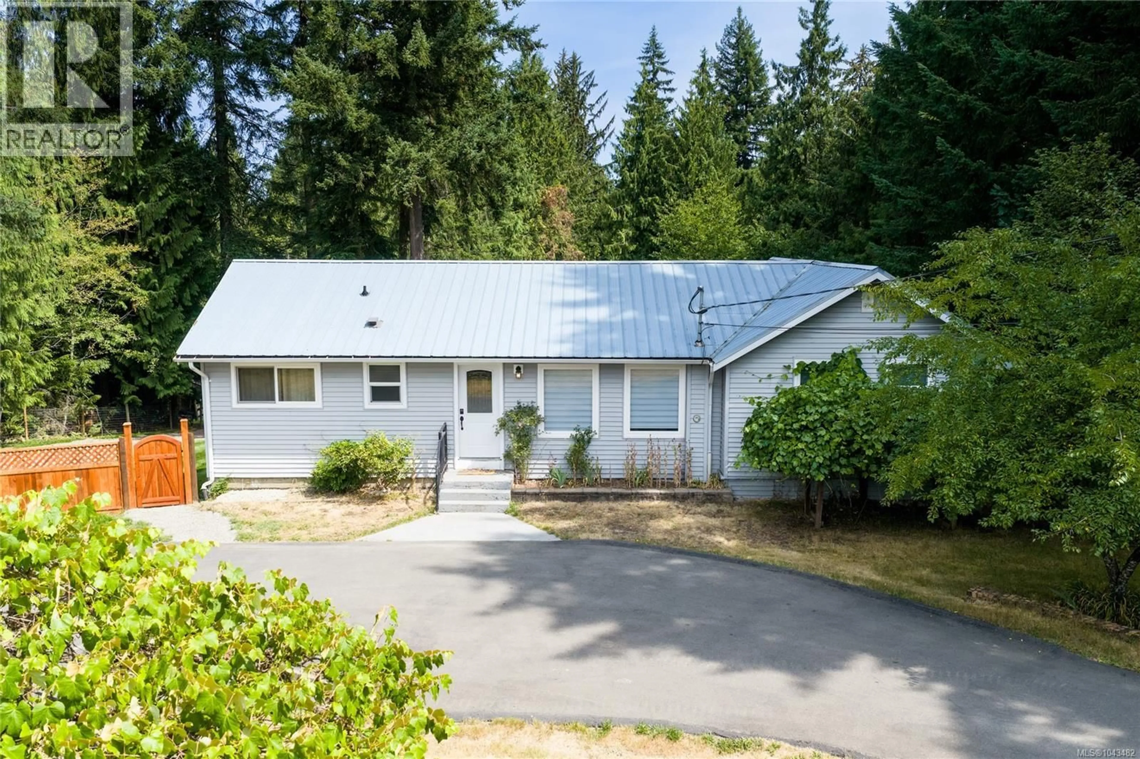 Home with vinyl exterior material, street for 3115 RINVOLD ROAD, Hilliers British Columbia V9K1X3
