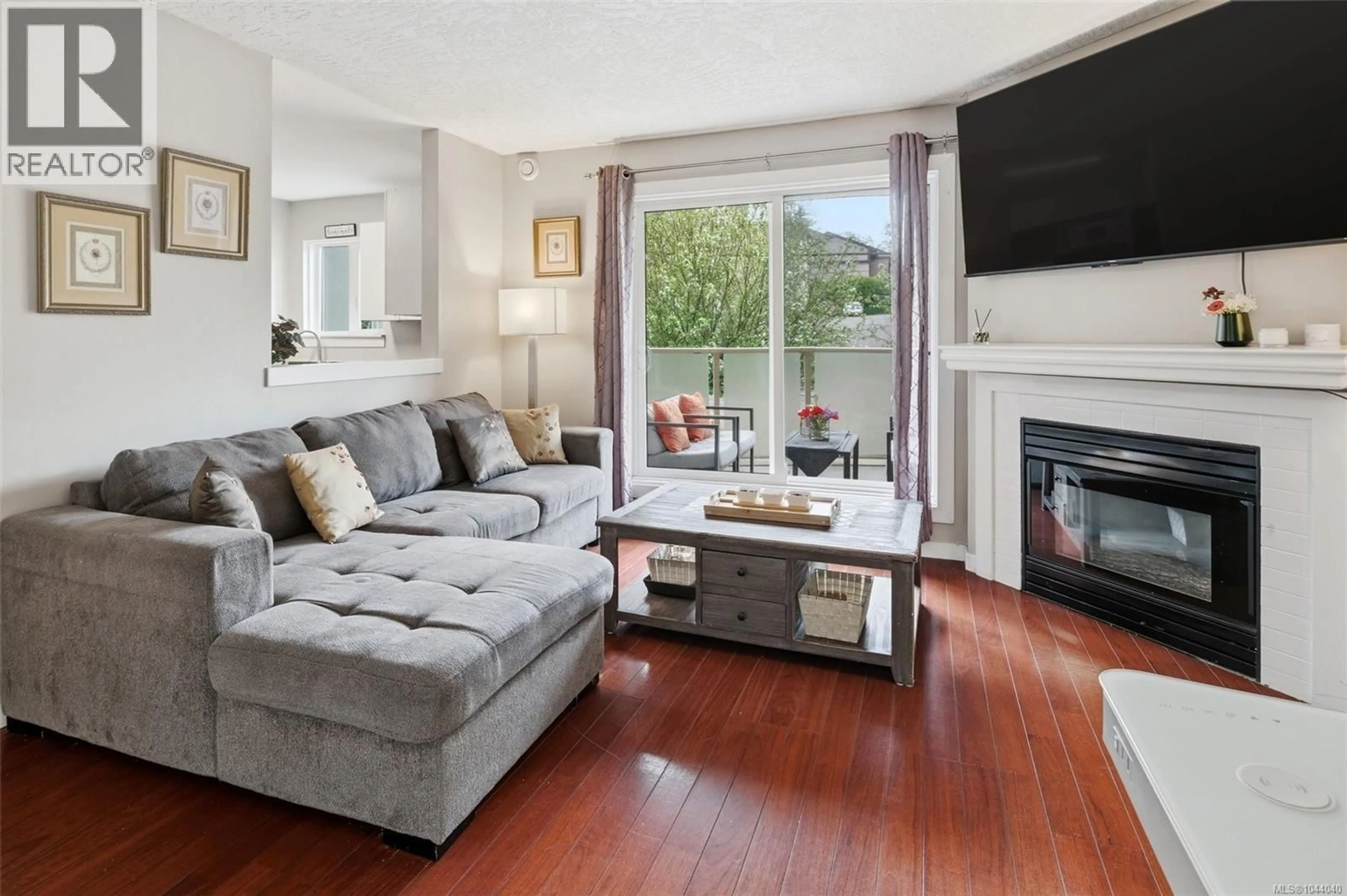 Living room with furniture, wood/laminate floor for 202 - 2710 GROSVENOR ROAD, Victoria British Columbia V8T3M9