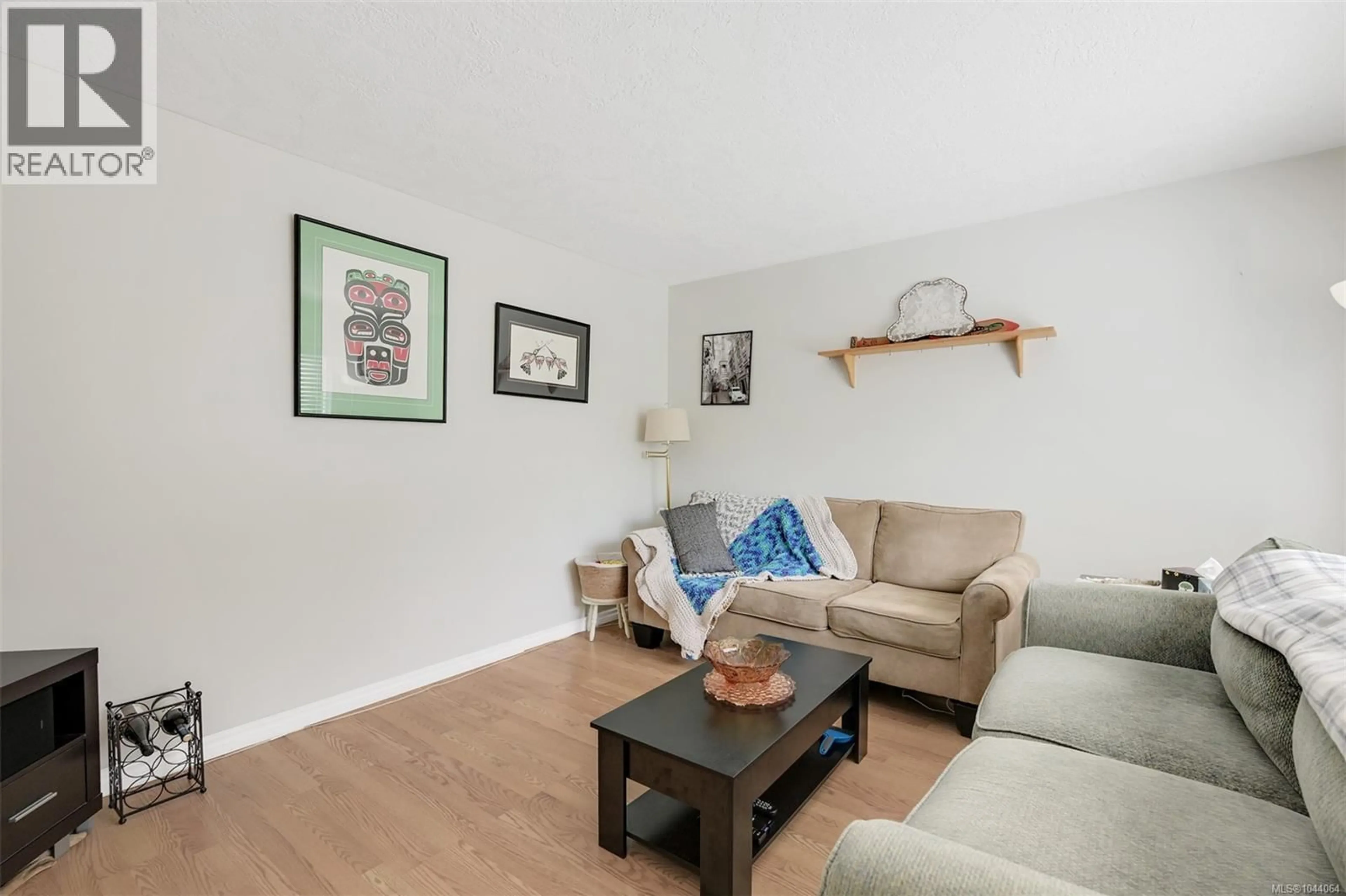Living room with furniture, wood/laminate floor for 111 - 2860 SOOKE LAKE ROAD, Langford British Columbia V9B4R3