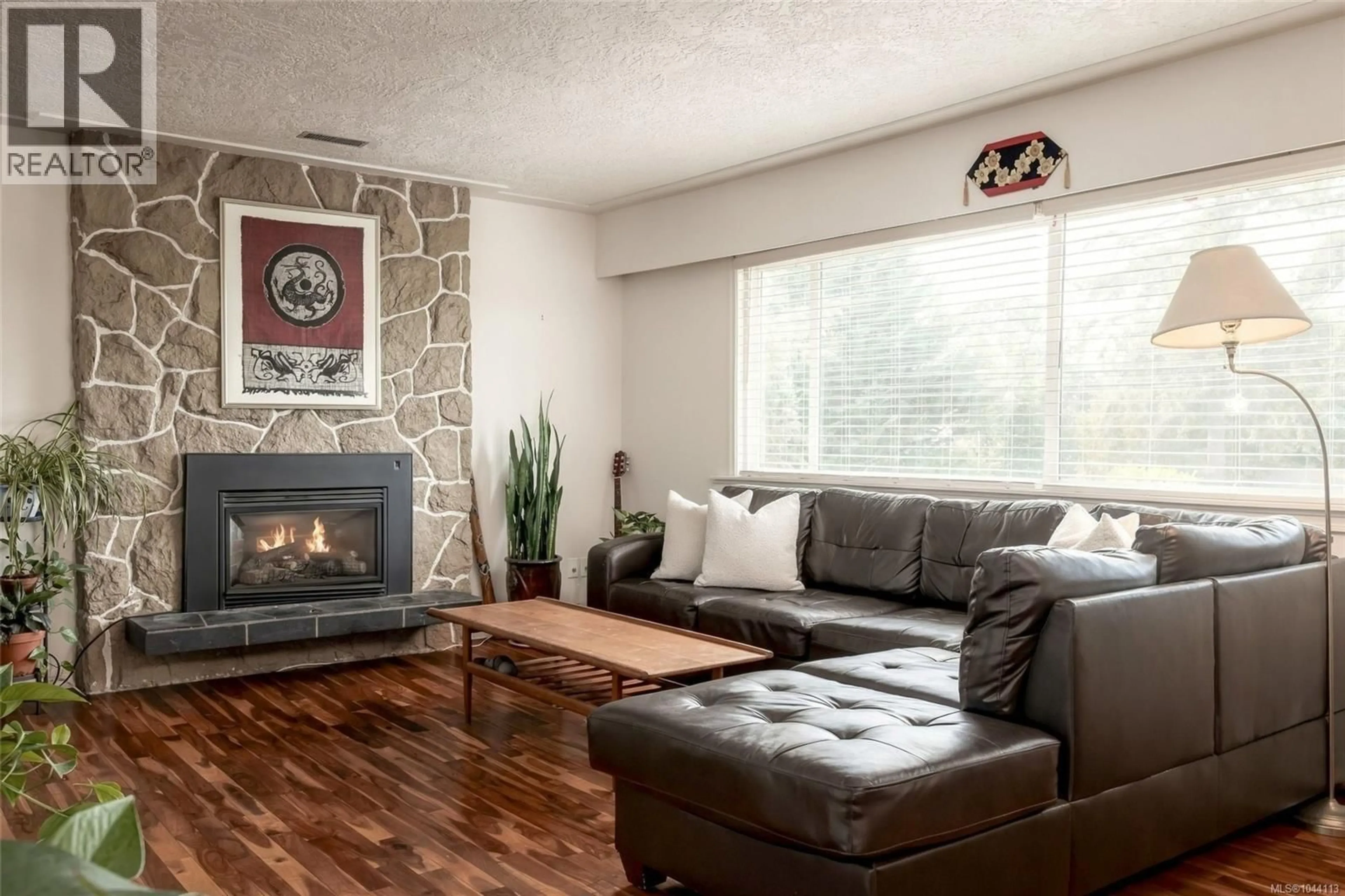 Living room with furniture, wood/laminate floor for 7031 WEST SAANICH ROAD, Central Saanich British Columbia V8M1G8