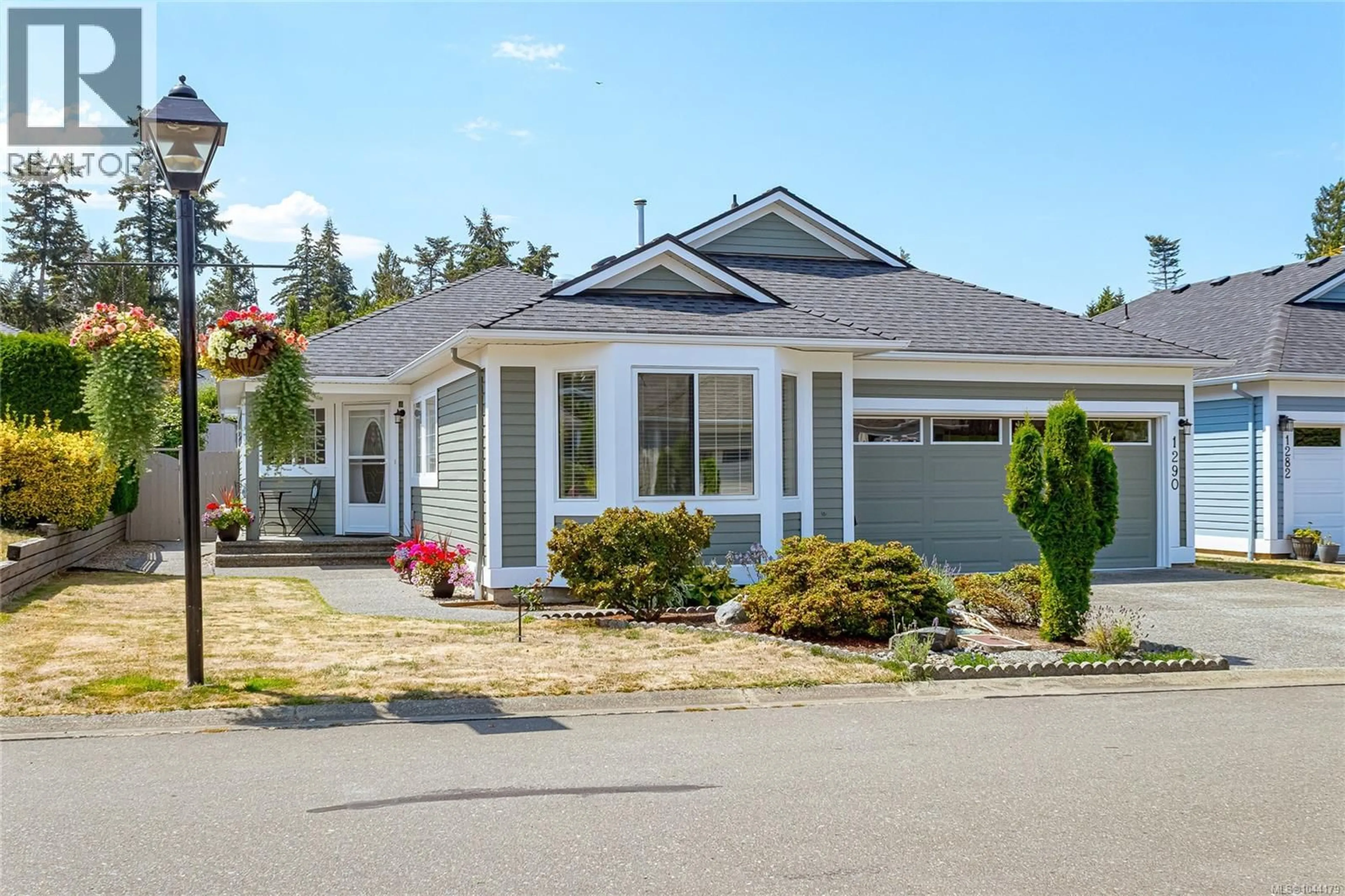 Home with vinyl exterior material, street for 1290 OCEANSIDE DRIVE, Qualicum Beach British Columbia V9K2K4