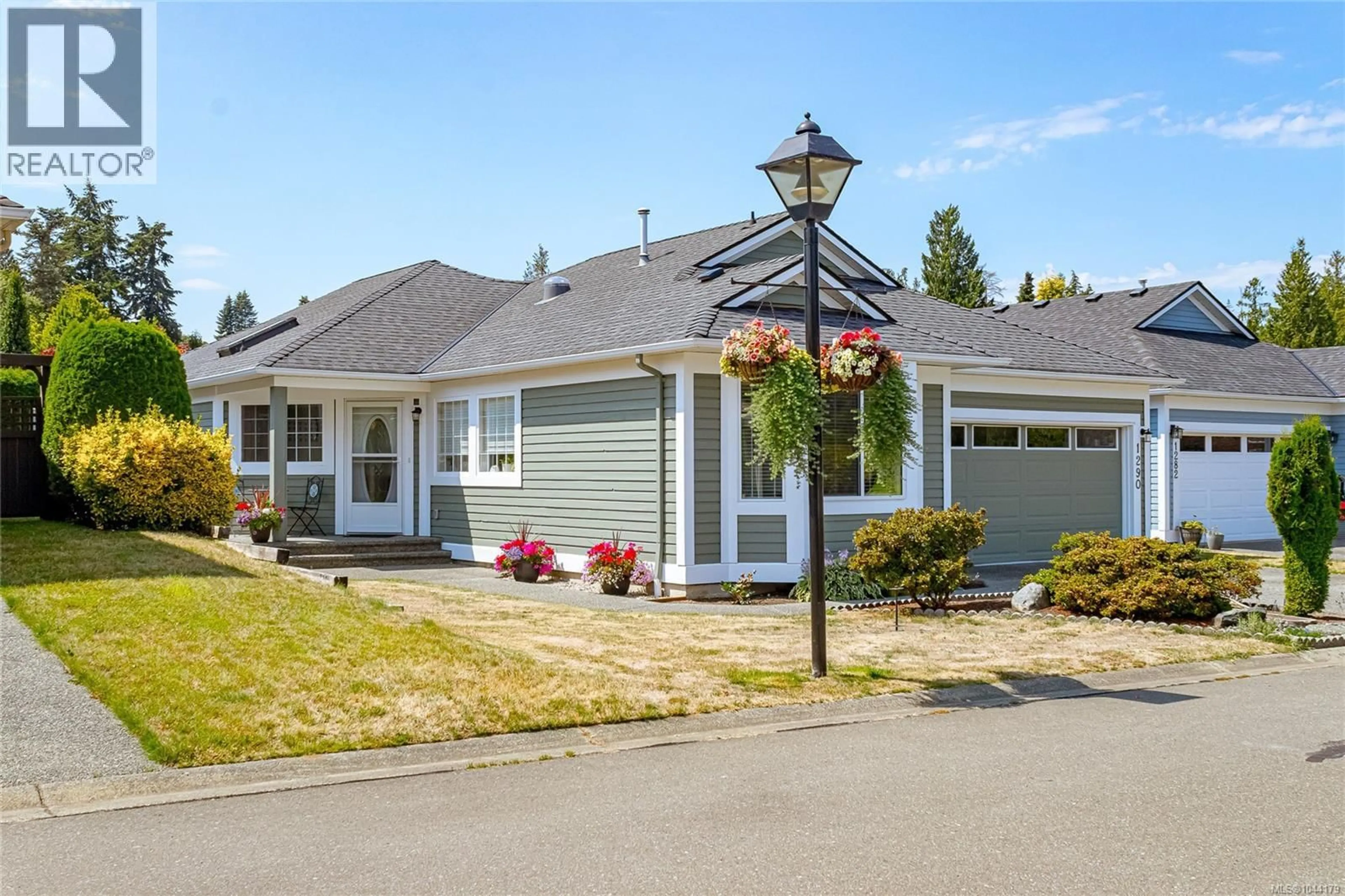 Home with vinyl exterior material, street for 1290 OCEANSIDE DRIVE, Qualicum Beach British Columbia V9K2K4